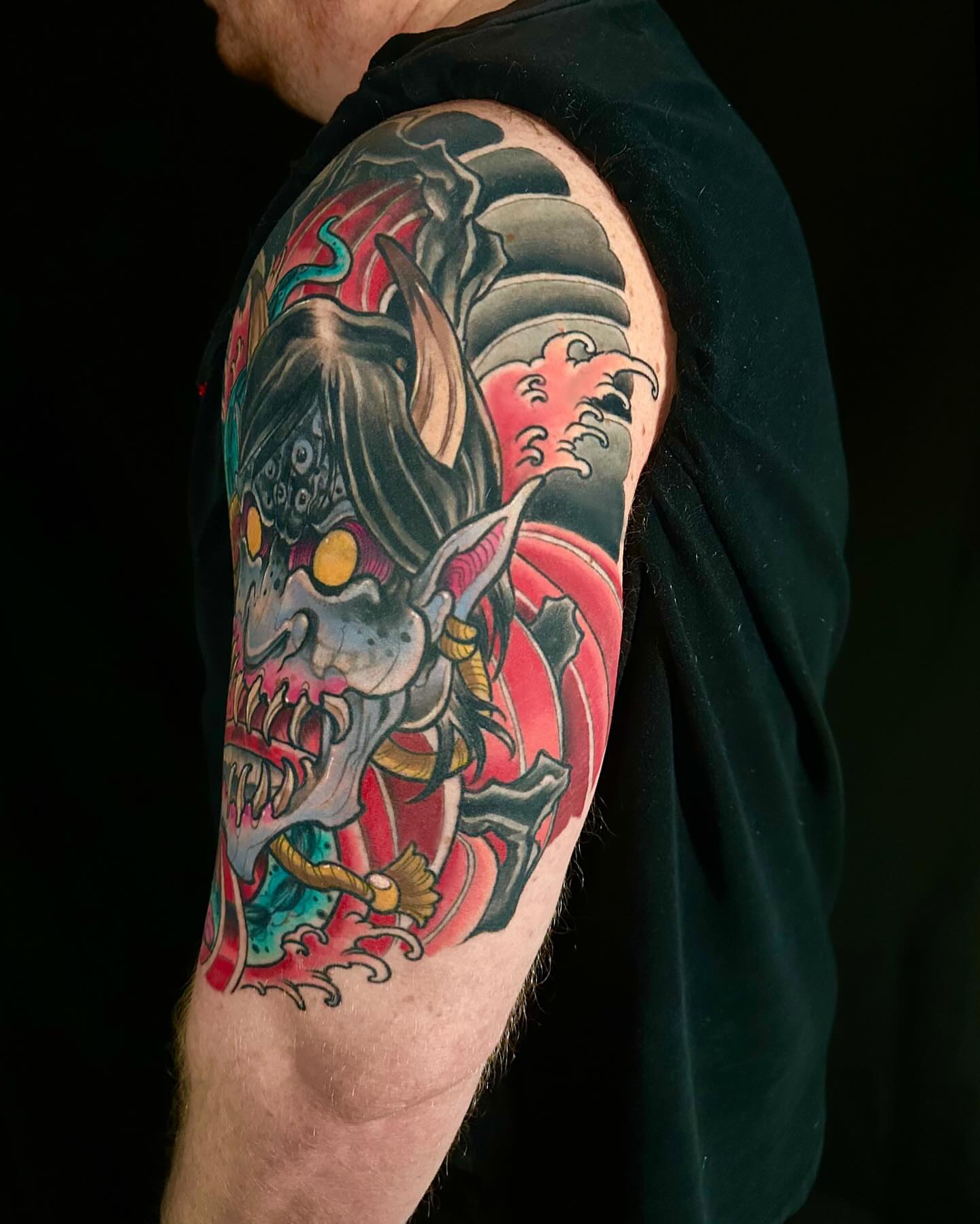 Demon mask japanese irezumi tattoo on the upper arm by John Milosh Chamberlin