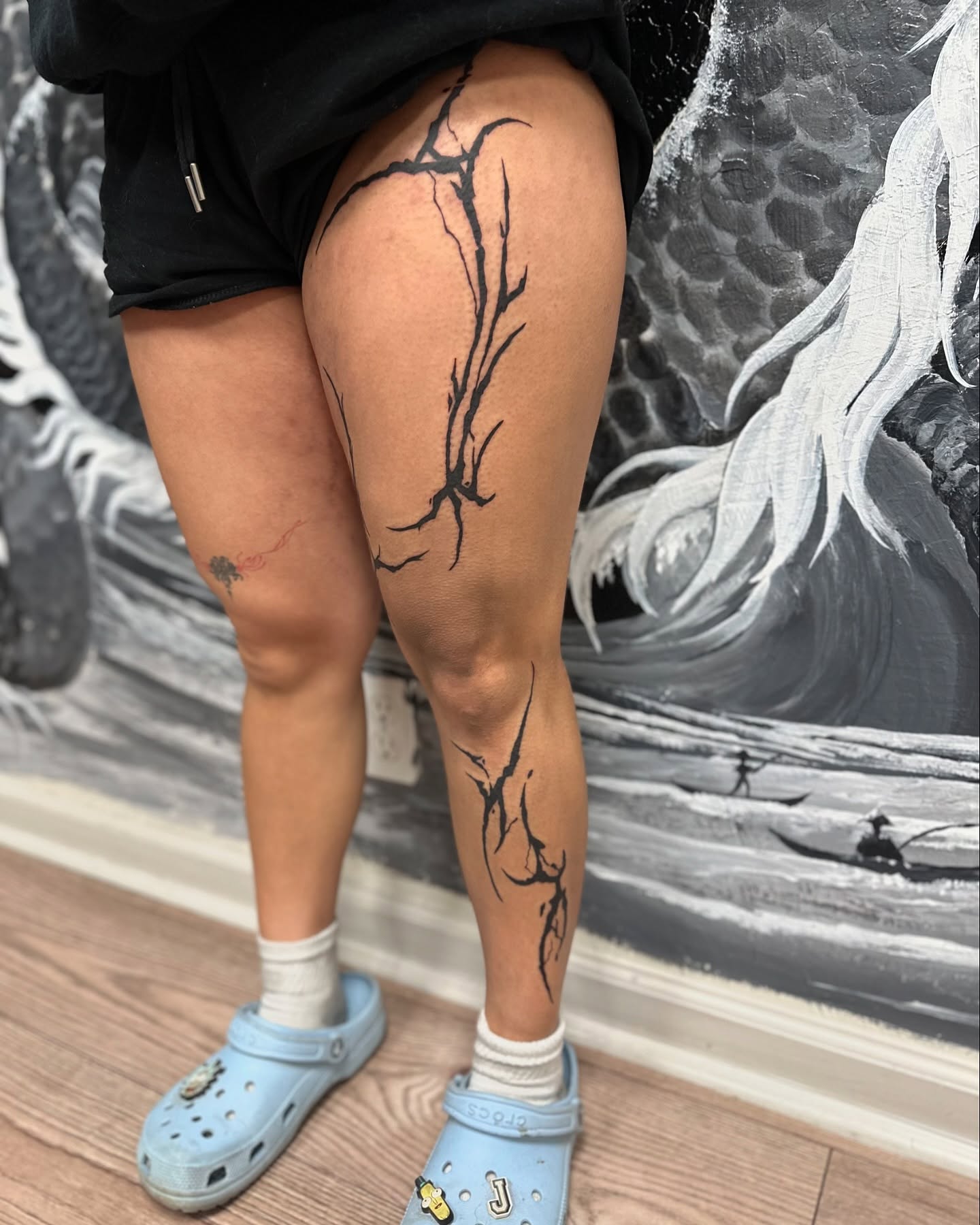 Branch tribal tattoo on the thigh by Roxanne Ochoa