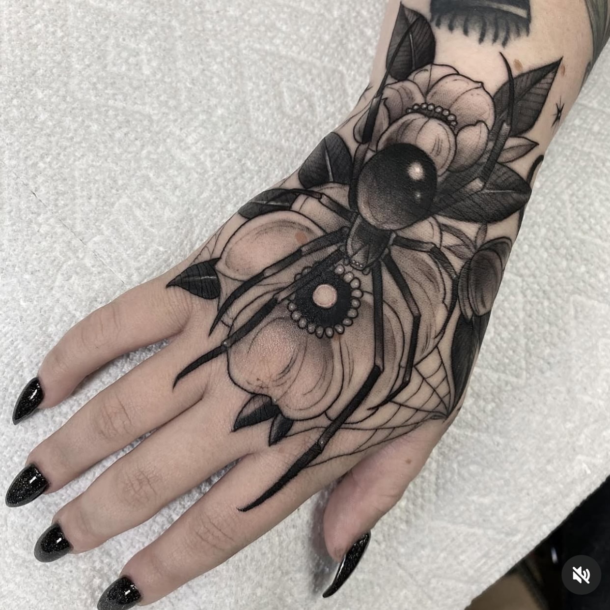 Spider and flowers realism tattoo on the hand by Marissa Tattoos