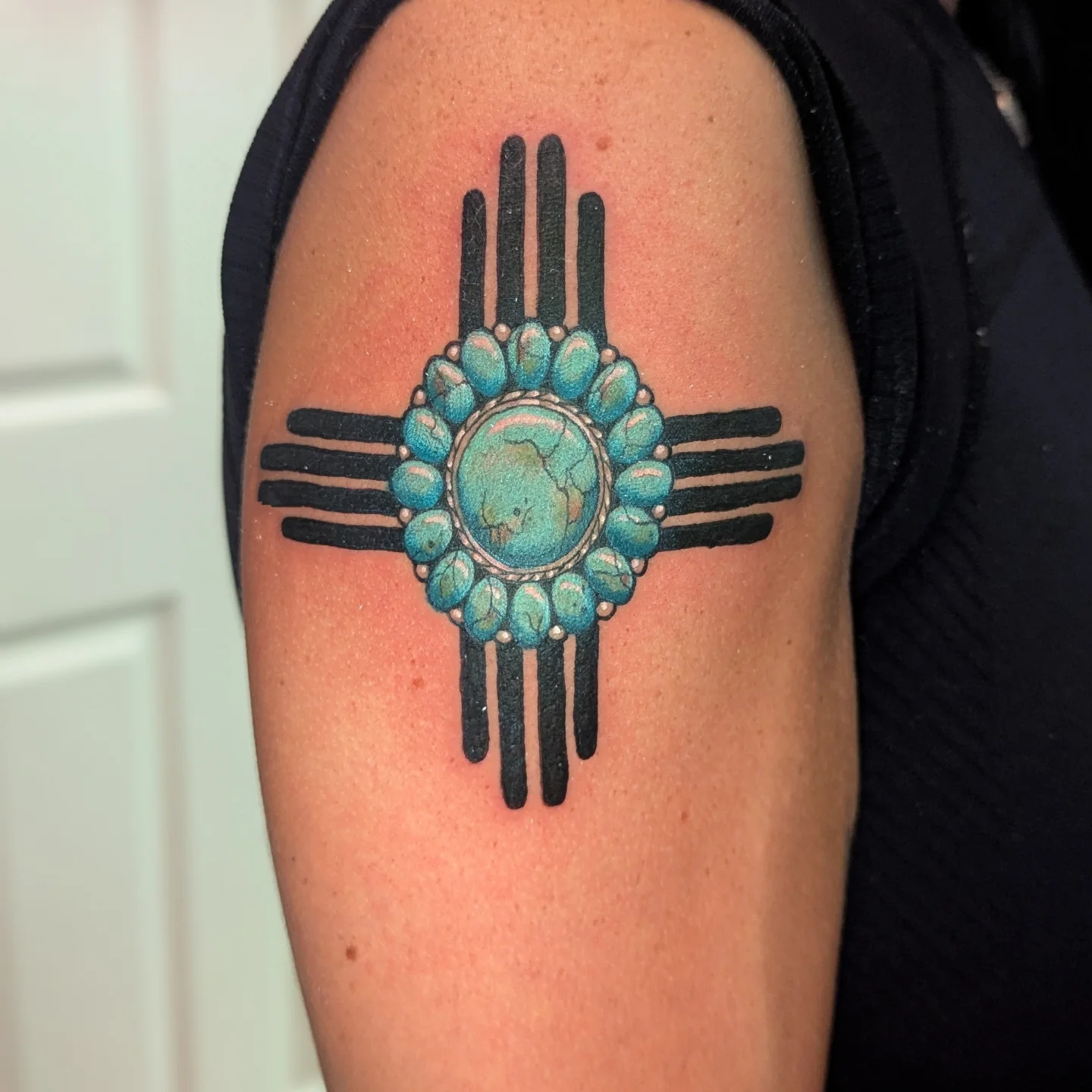 Zia symbol American traditional tattoo on the shoulder by Bethany Jane Tattoos