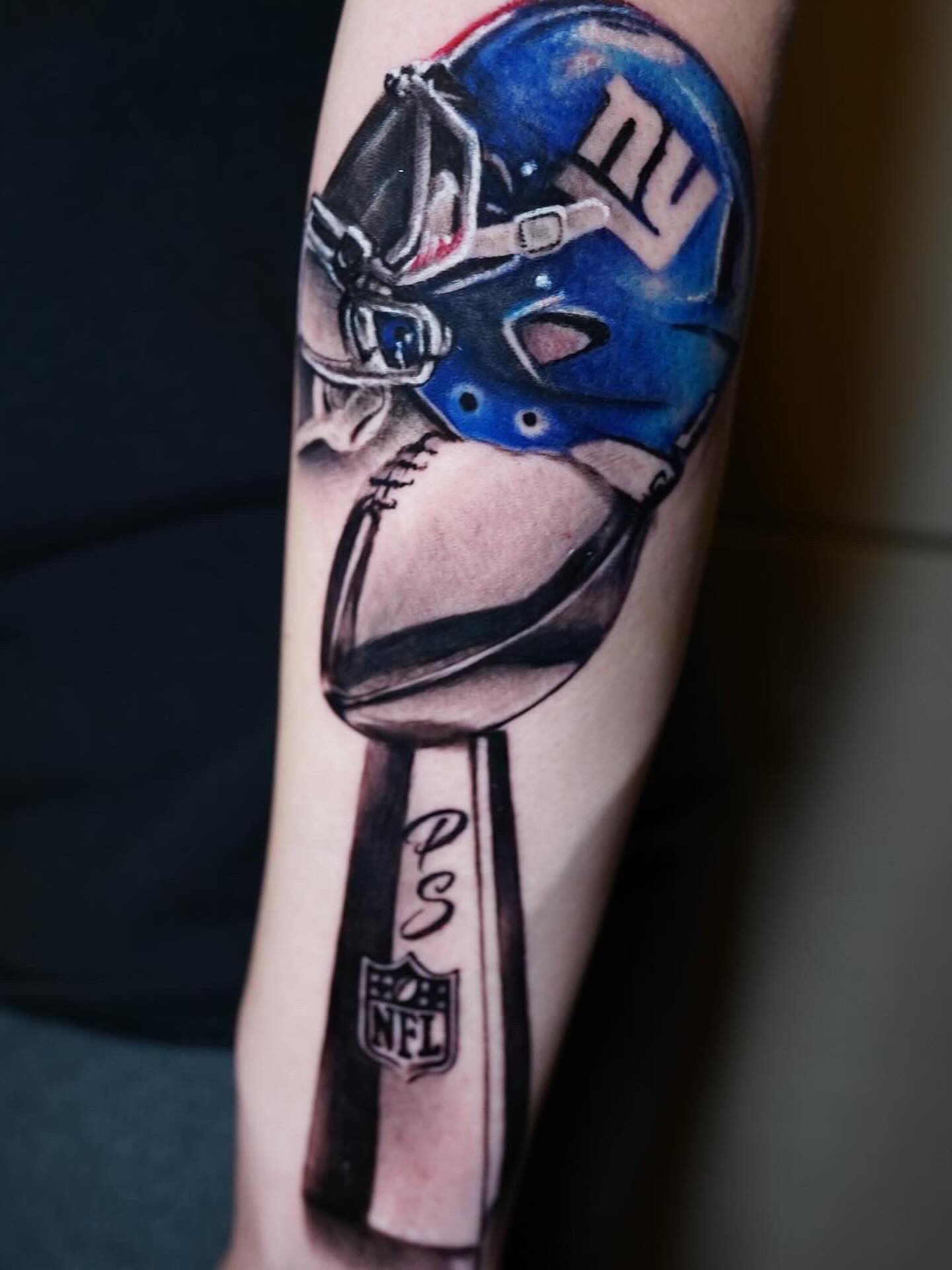 Football helmet realism tattoo on the forearm by Erick Satchell II