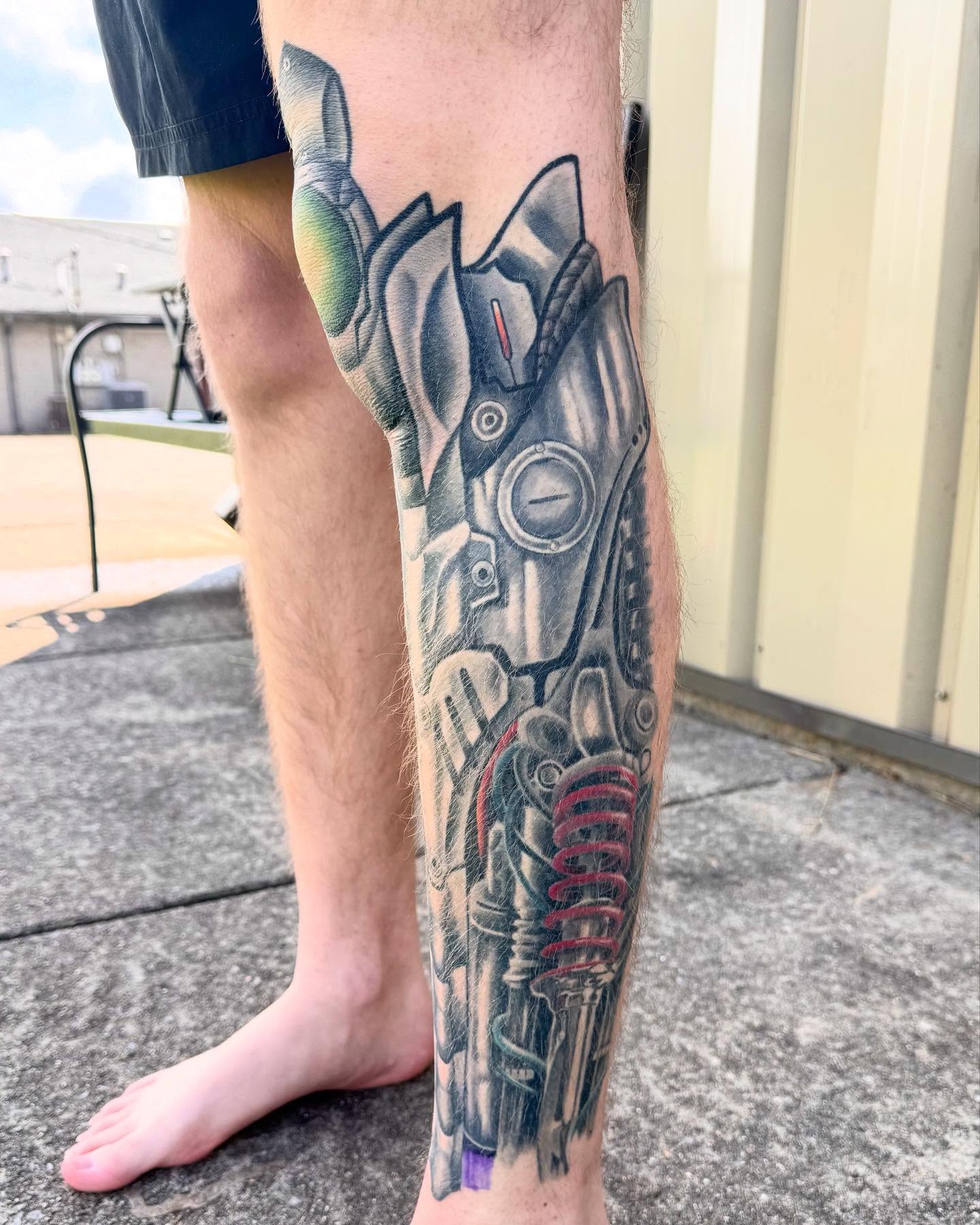 Mech realism tattoo on the calf by Chris Lochbihler