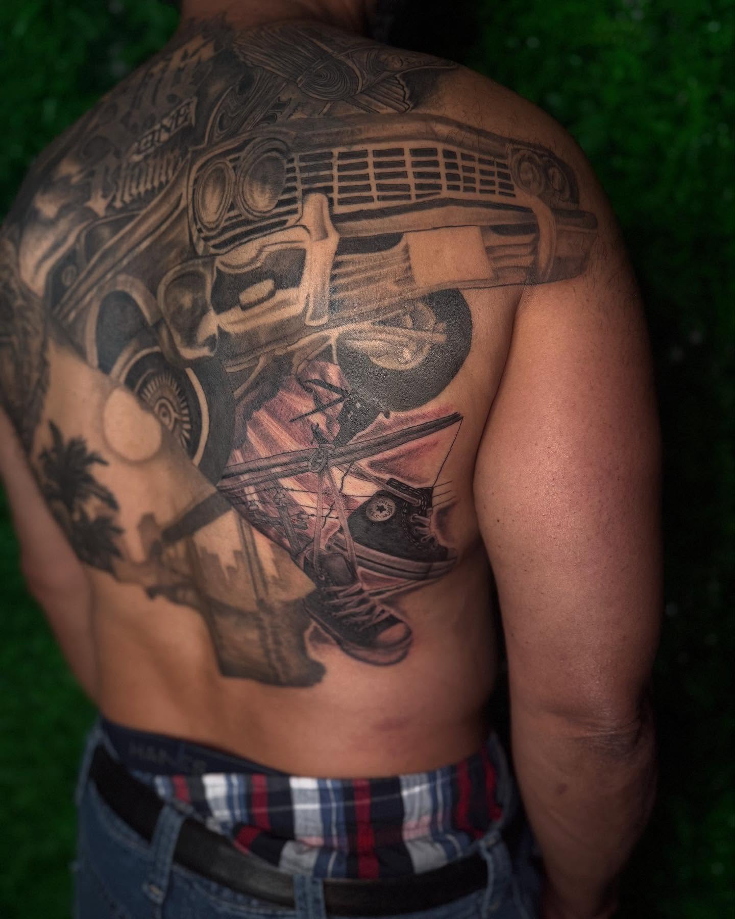 Car and airplane realism tattoo on the back by Los Angeles Tattoo Artist