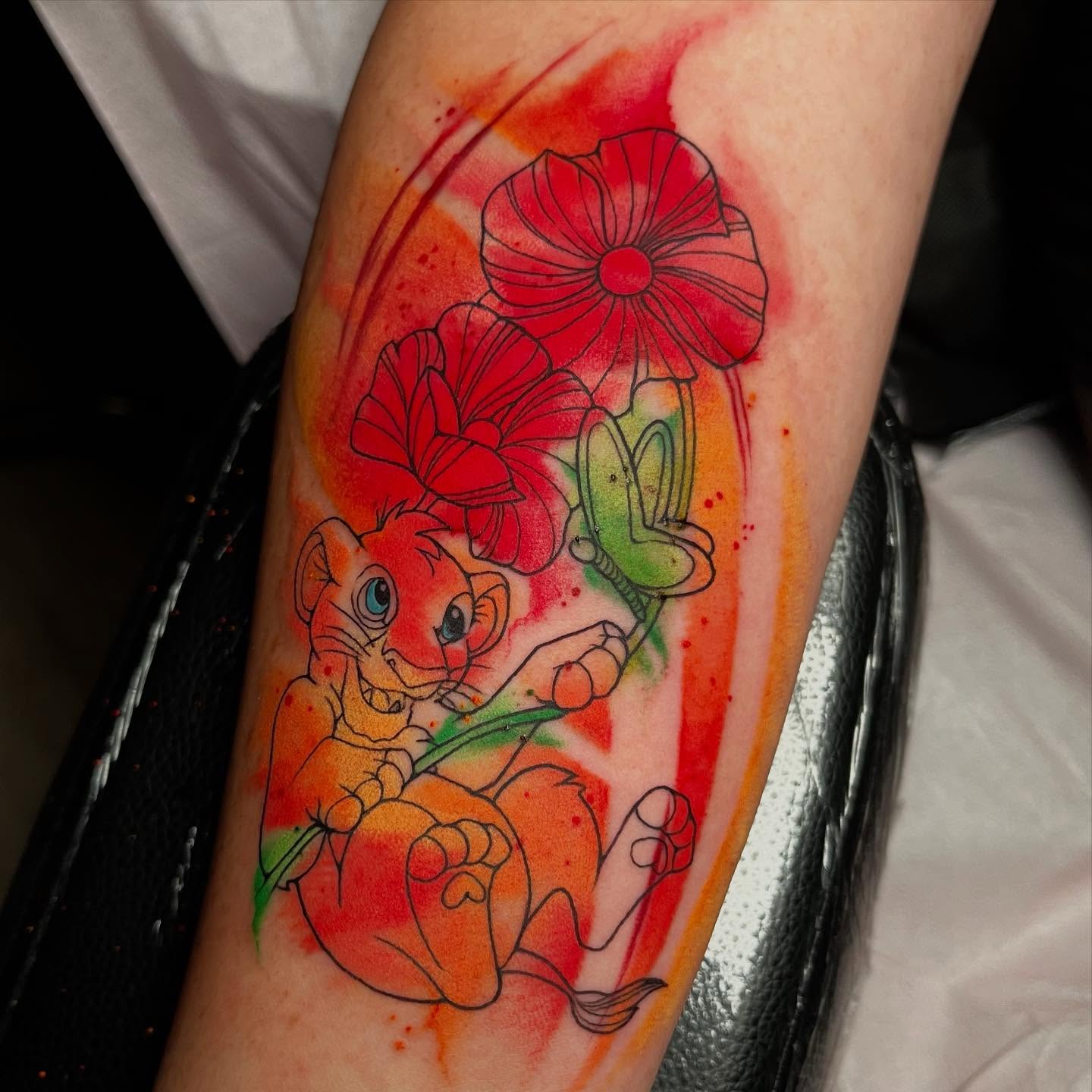 Lion cub with flowers watercolor tattoo on the forearm by 🪴Amanda Lugo🪴 Ocala Tattoo Artist