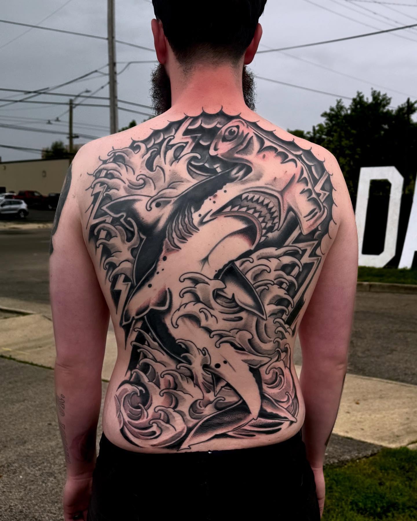 Fish and waves japanese irezumi tattoo on the back by Ryan Engels