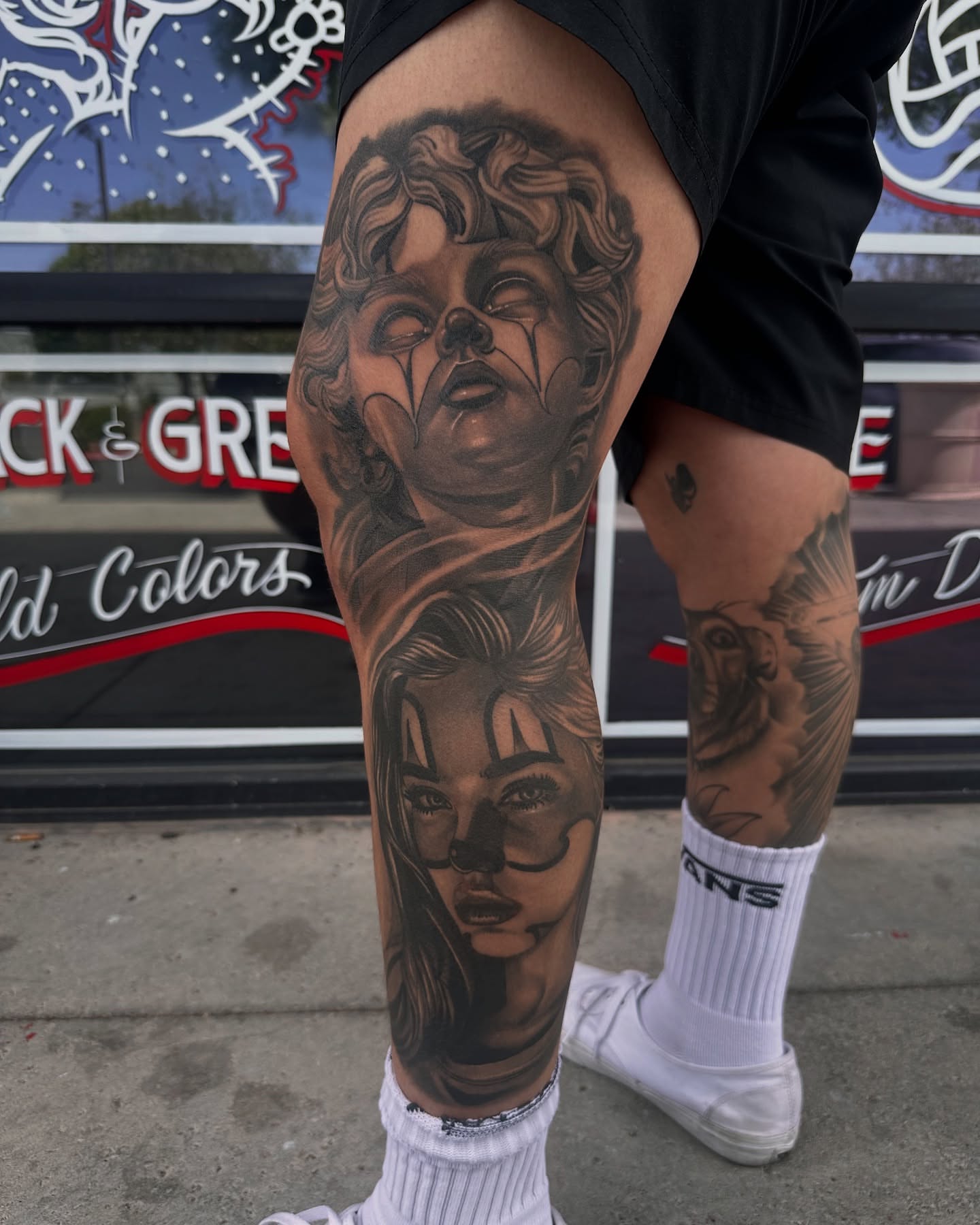 Female faces realism tattoo on the thigh by Travis