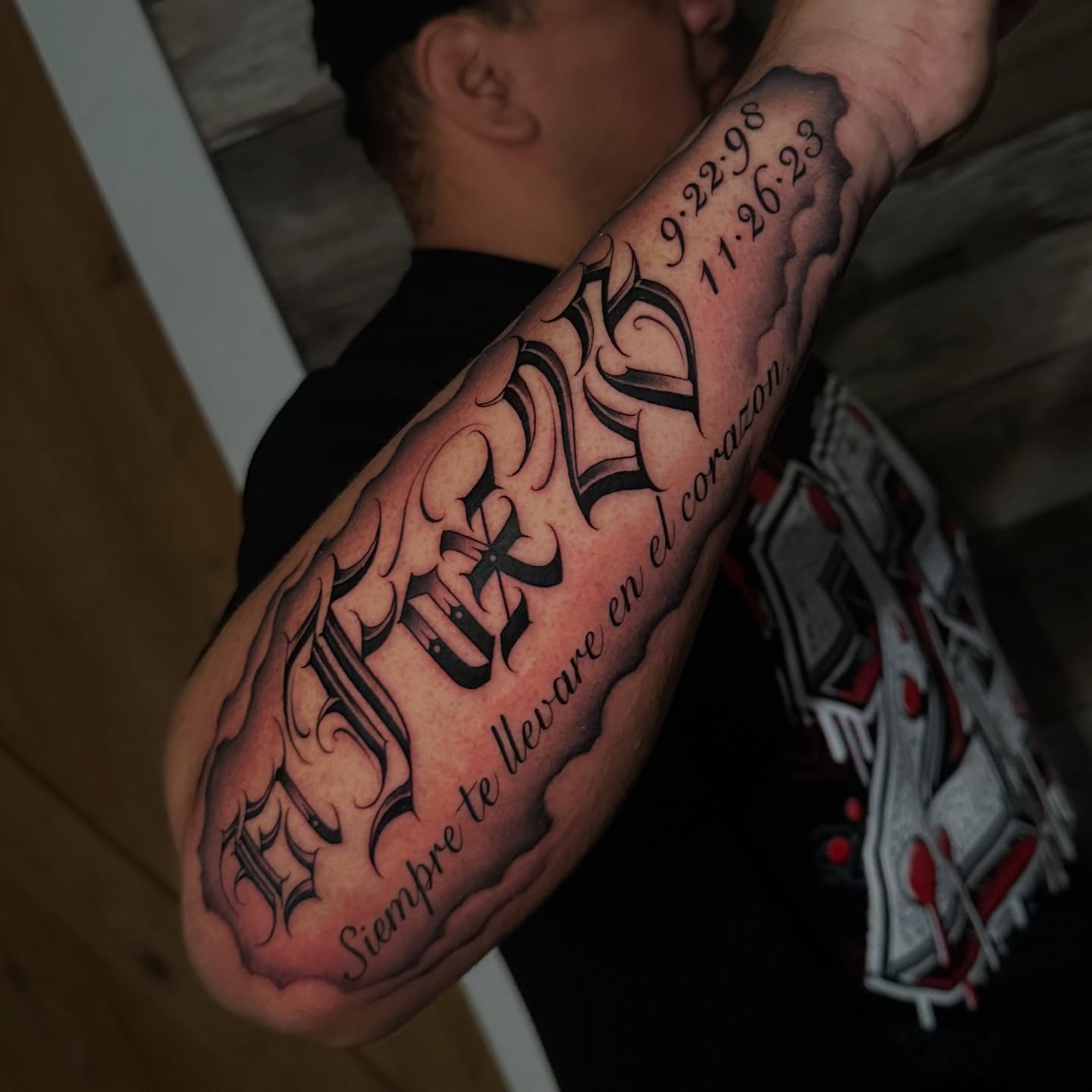 Flame and cross black and grey tattoo on the forearm by Atlanta Tattoo Artist, Atlanta, Georgia