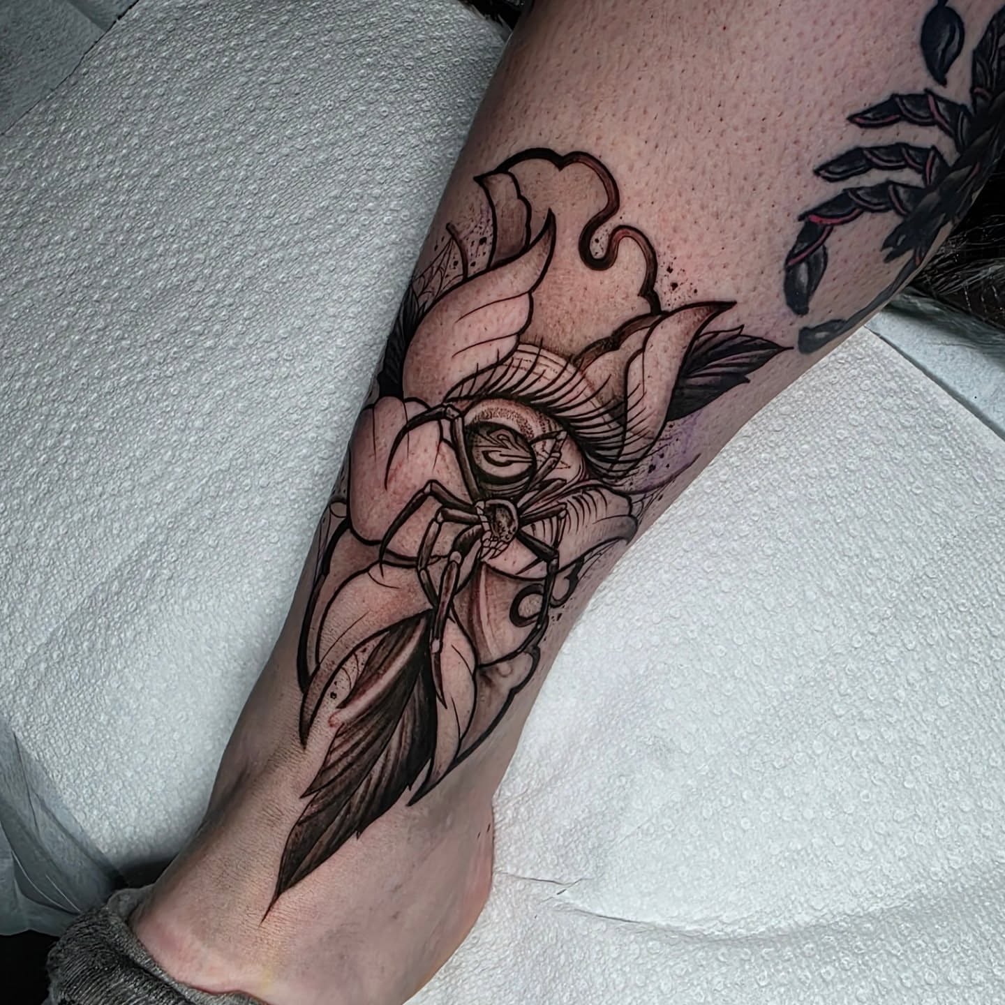 Insect and flower black and grey tattoo on the forearm by Kelsey Lorrae, Ankeny, Iowa