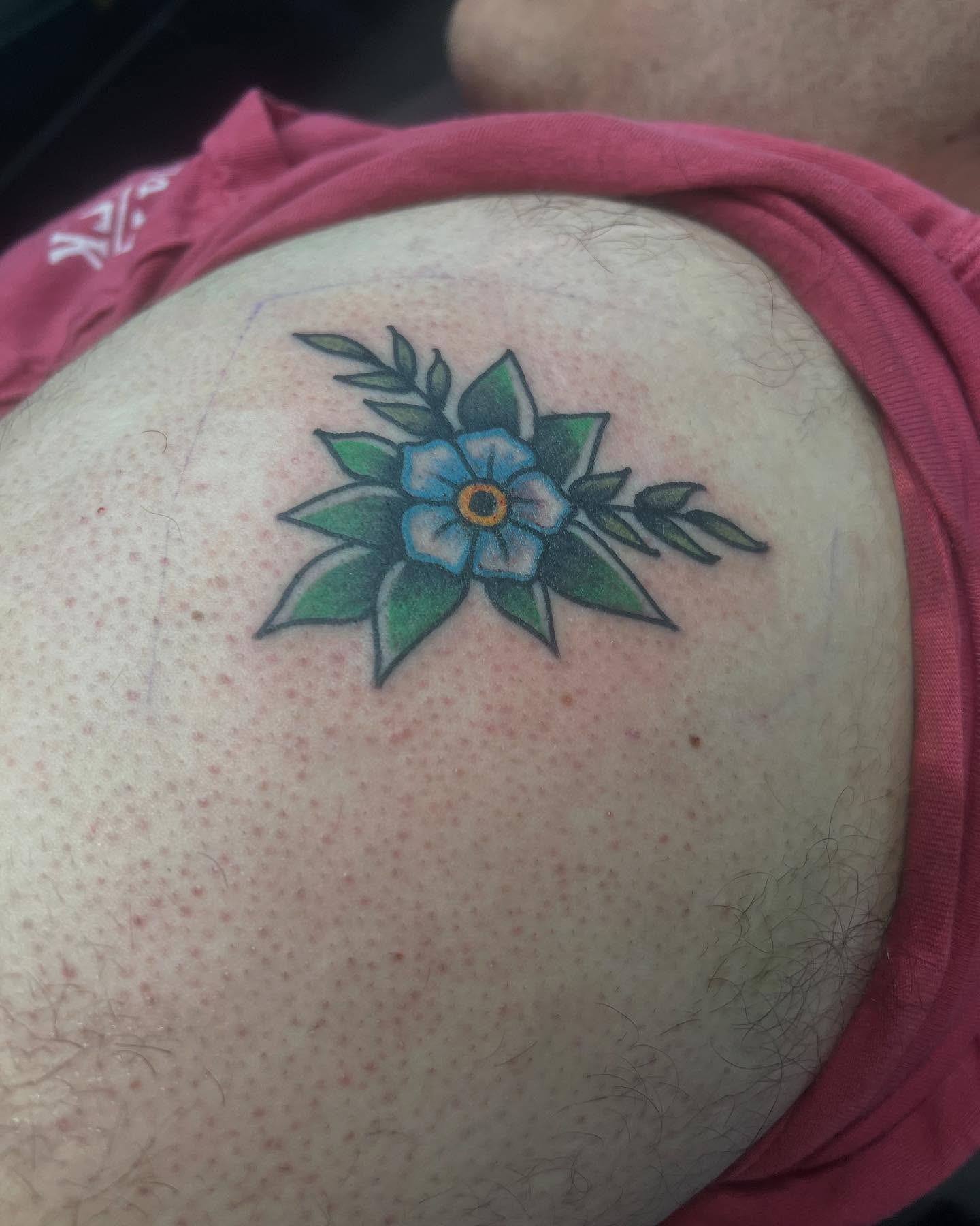 Forget-me-not flower American traditional tattoo on the torso by Mika Clairissa