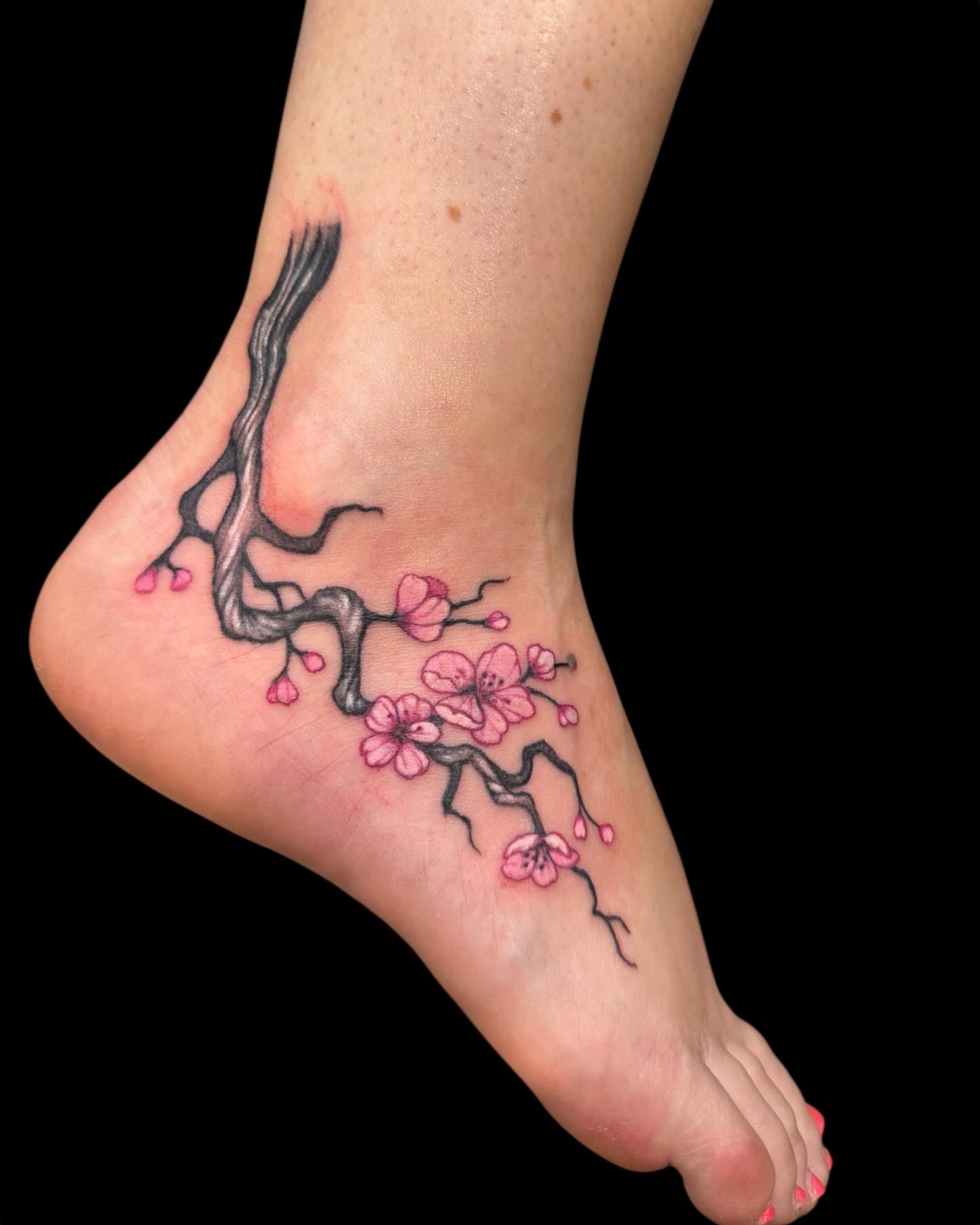 Cherry blossom branch realism tattoo on the foot by Brennan Walker, Orem, Utah