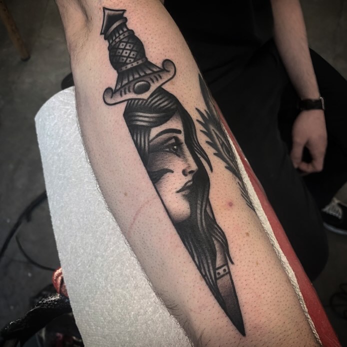 Woman with hat American traditional tattoo on the forearm by andrewtattoos