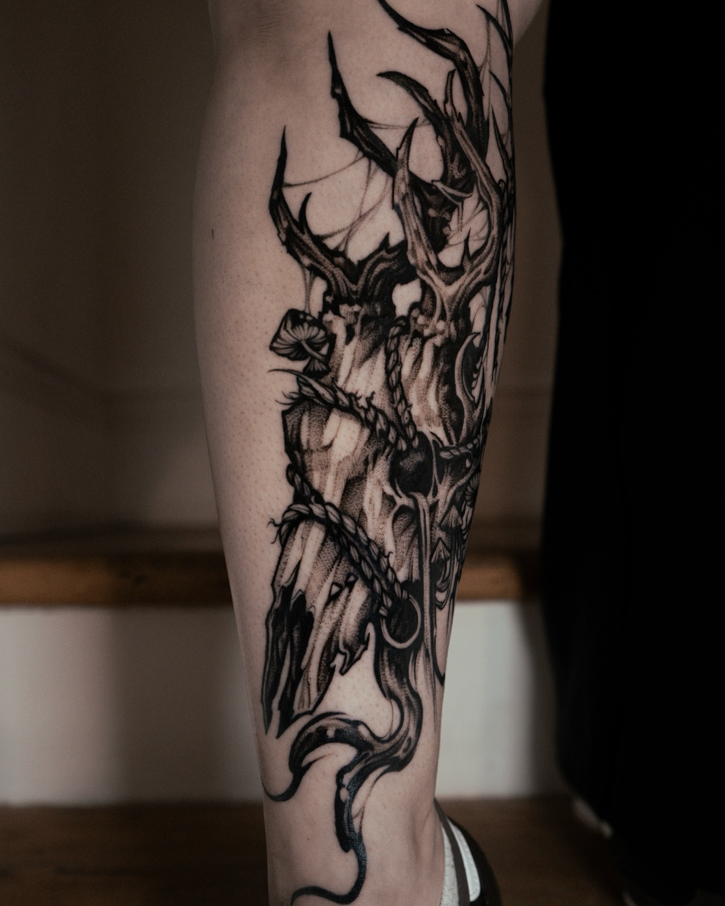 Stag and dragon dark realism tattoo on the forearm by Bruna Bianculli