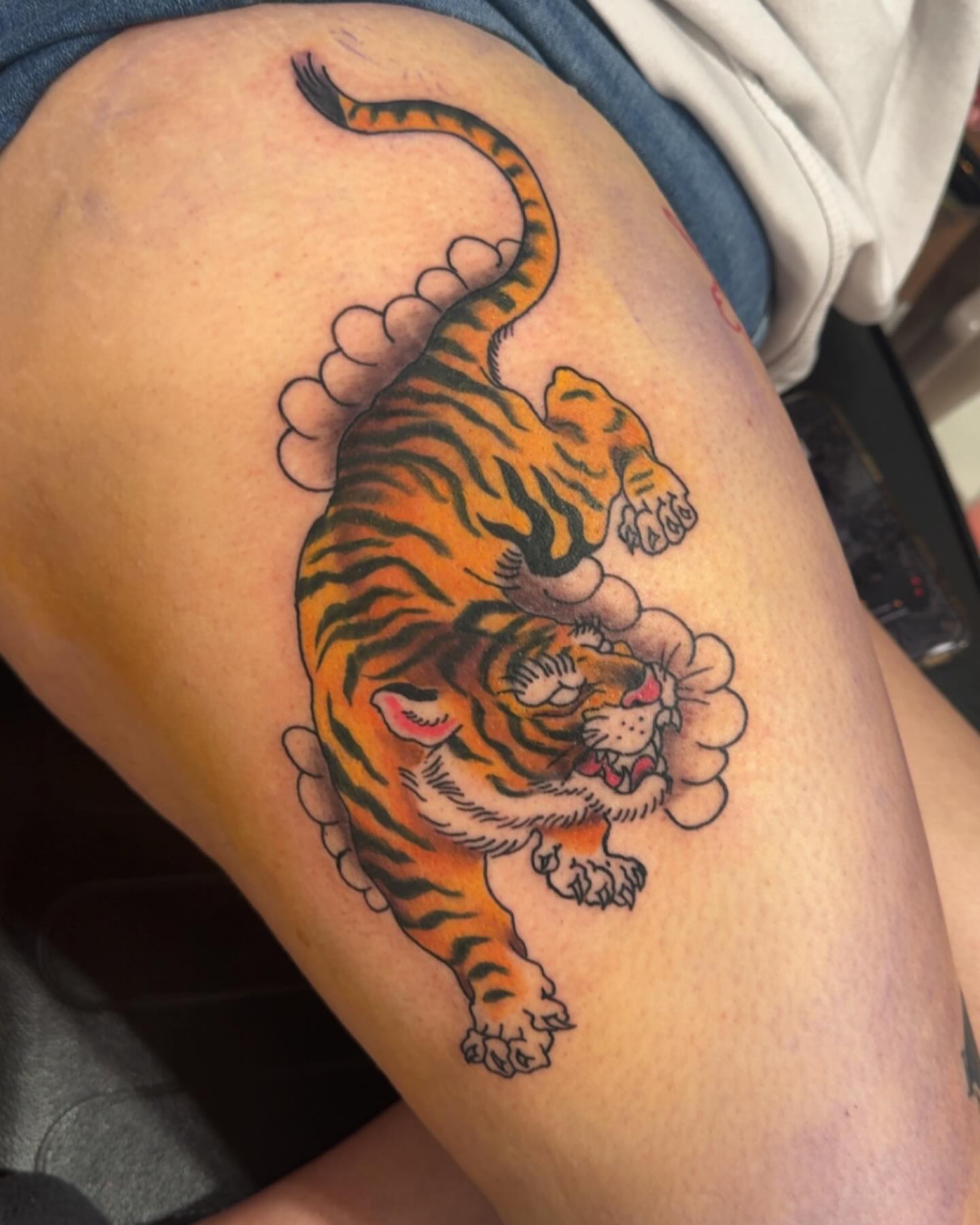 Tiger American traditional tattoo on the thigh by Robbie Roberson