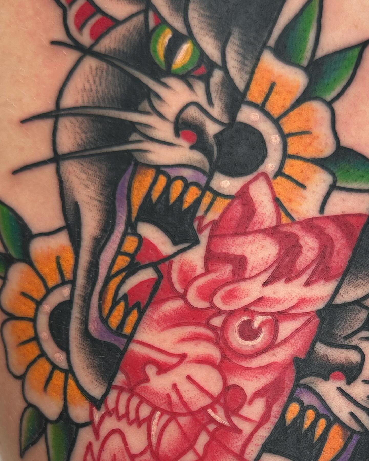 Cat and flower American traditional tattoo on the forearm by Mikey Sarratt