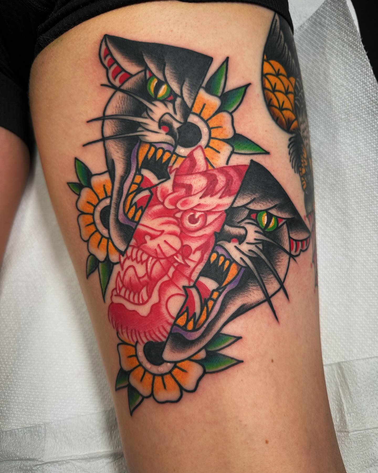 Cat and flower American traditional tattoo on the thigh by Mikey Sarratt