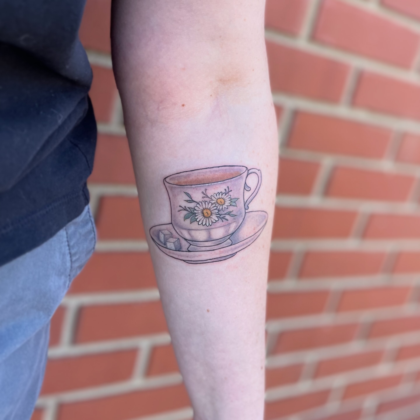 Teacup and flowers dotwork tattoo on the forearm by Liv