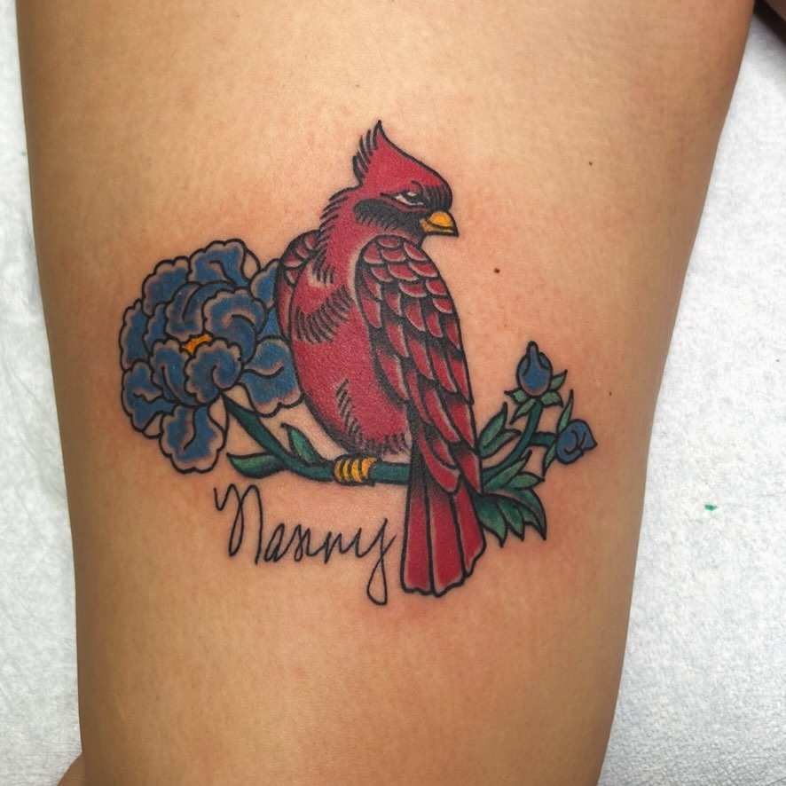 Cardinal and flowers American traditional tattoo on the thigh by Elizabeth Niederkorn