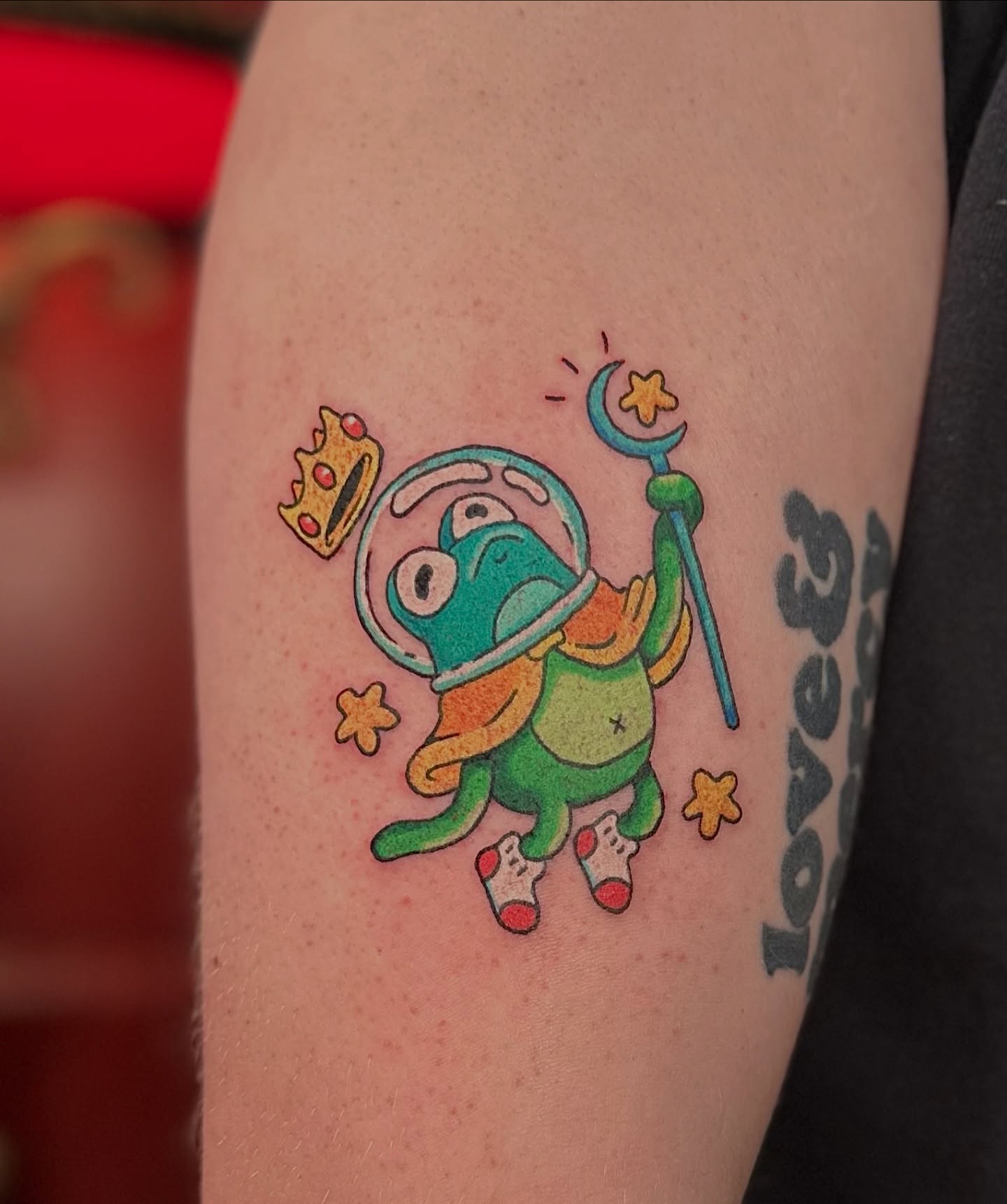 Frog astronaut new school tattoo on the forearm by Kellie Burch