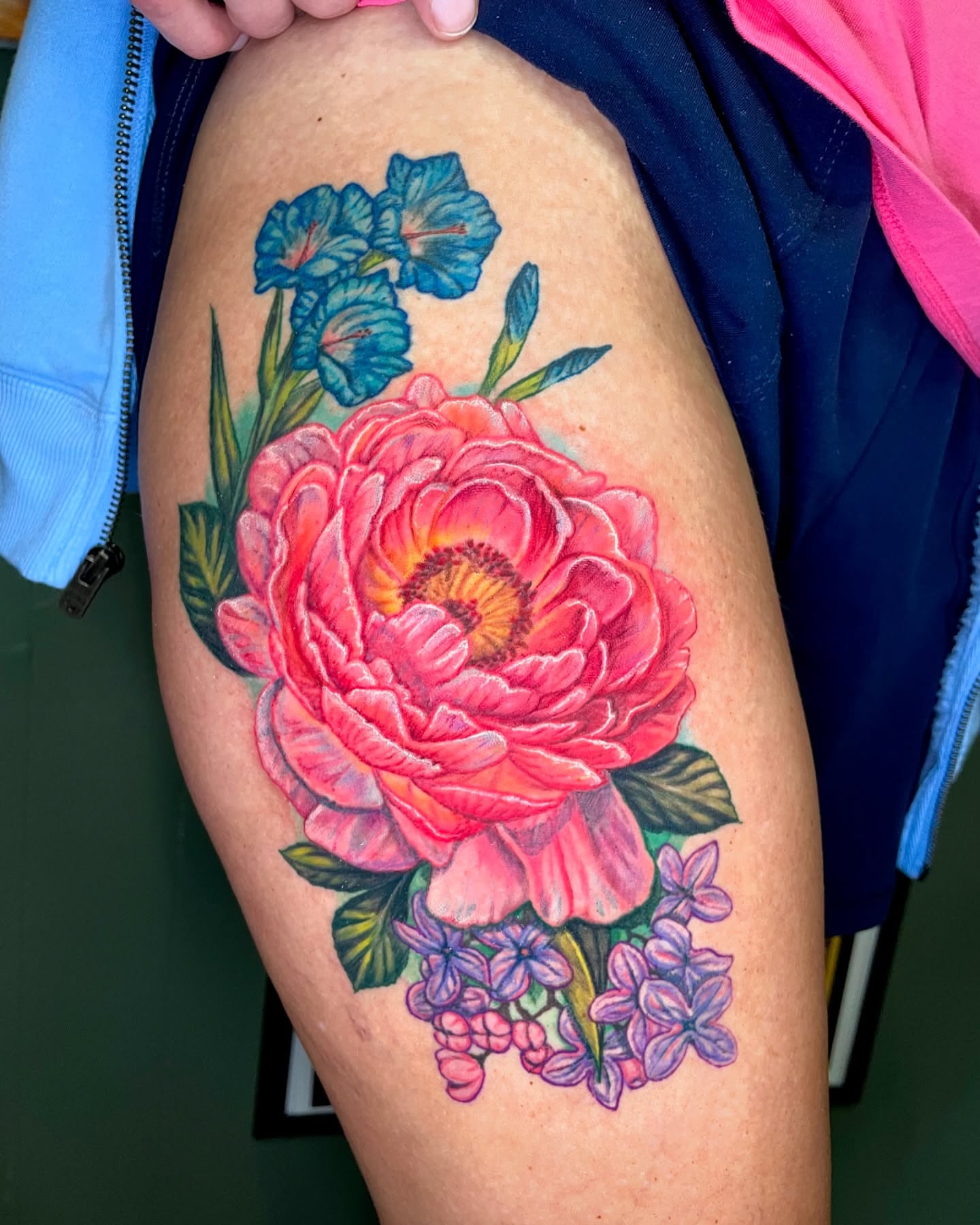 Peony and flowers watercolor tattoo on the thigh by Rick Elliott