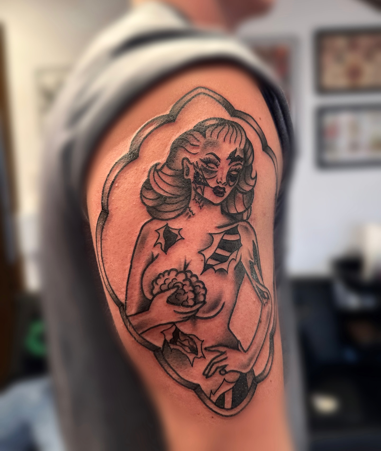 Pin-up girl American traditional tattoo on the upper arm by juice🕷tattoo artist