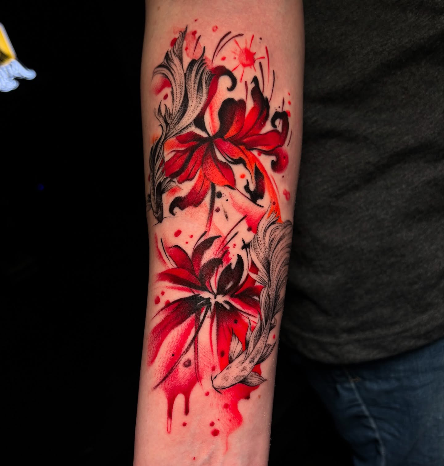 Red flowers watercolor tattoo on the forearm by ππππππ