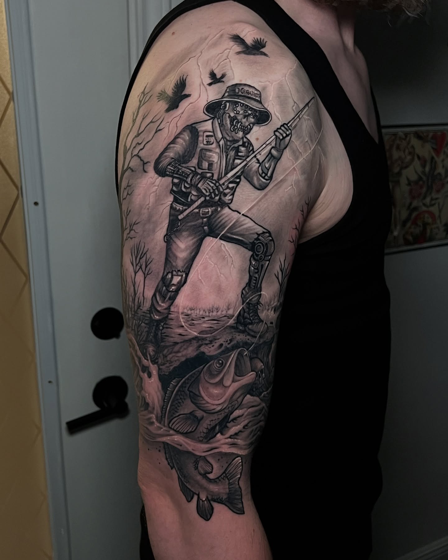 Soldier fishing realism tattoo on the upper arm by Raul Ortiz