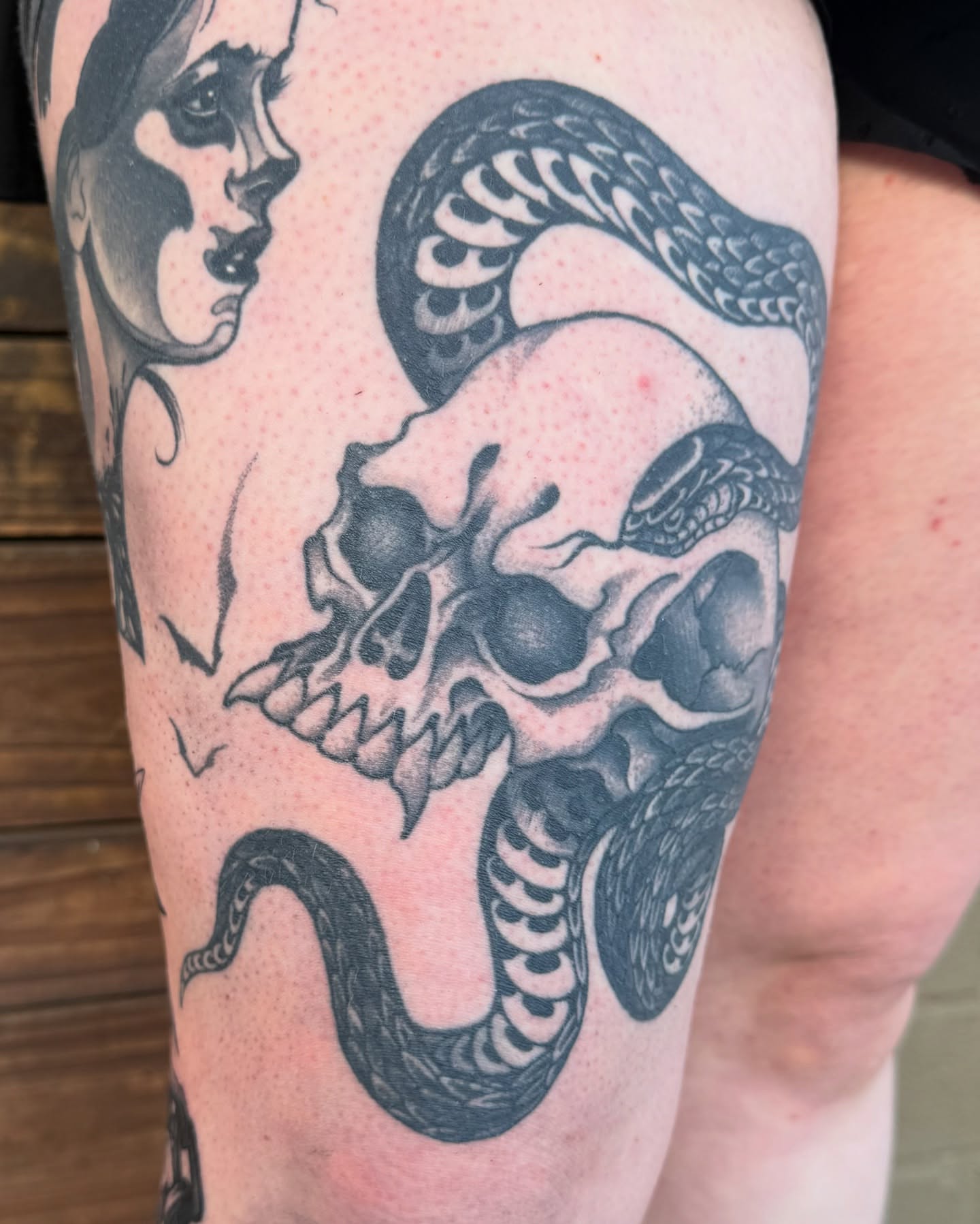 Skull and snake dotwork tattoo on the thigh by Scott Kulikowski