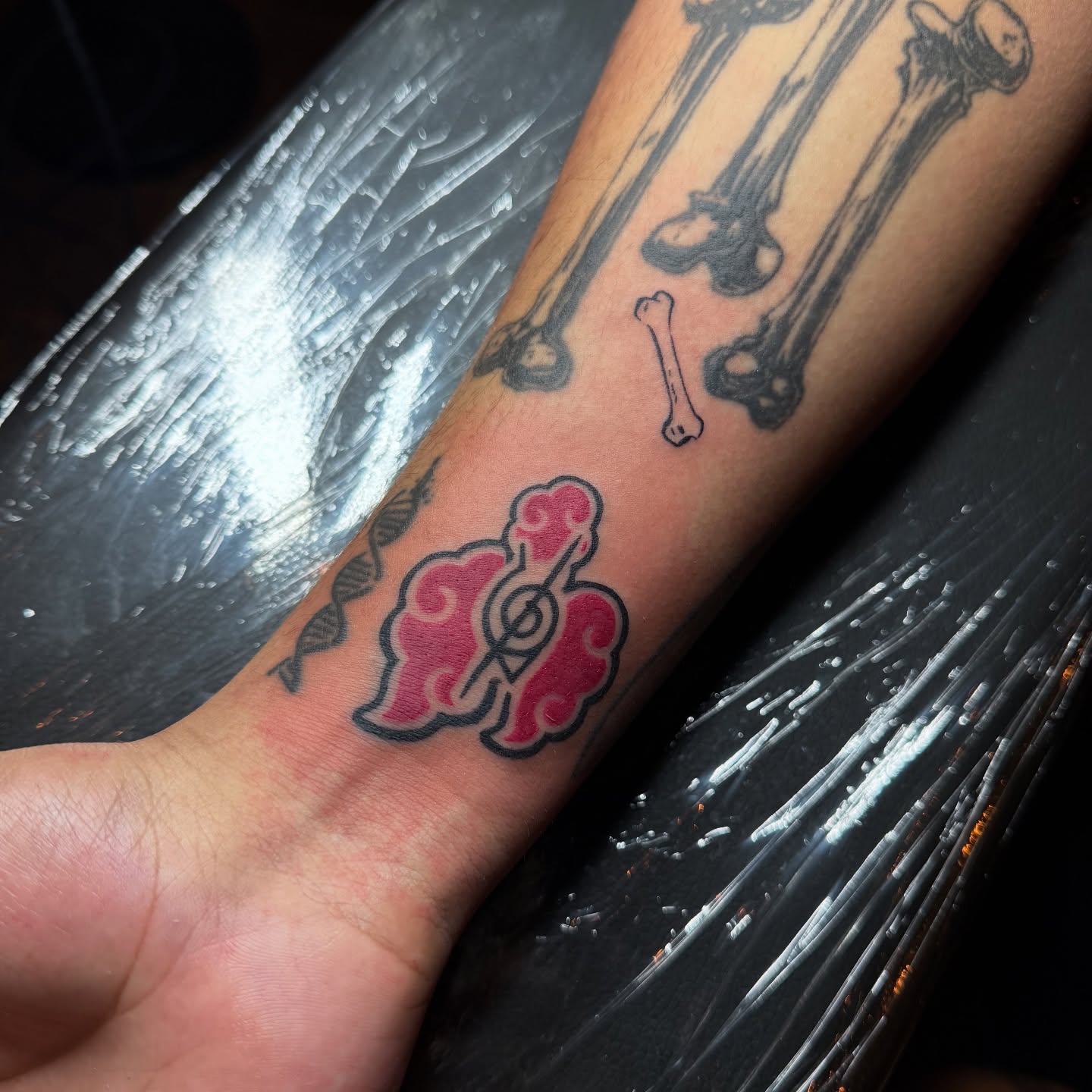 Musical note and cloud dotwork tattoo on the forearm by Jevon Glasco Tattoos