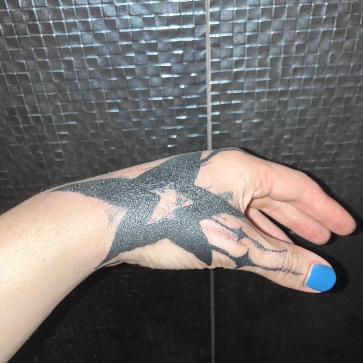 Cat black and grey tattoo on the hand by @godsfirmgrip