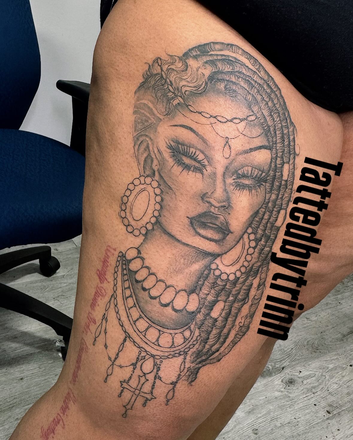 Woman with braids realism tattoo on the thigh by Tattedbytrinn