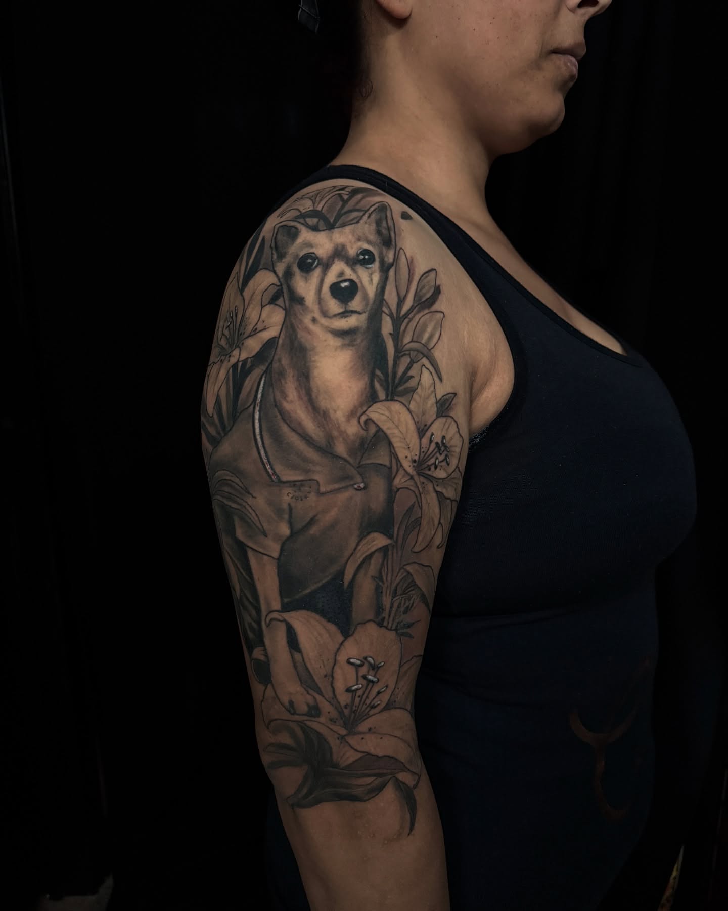 Dog and lilies realism tattoo on the upper arm by Las Vegas Japanese Tattoo Artist, Las Vegas, Nevada