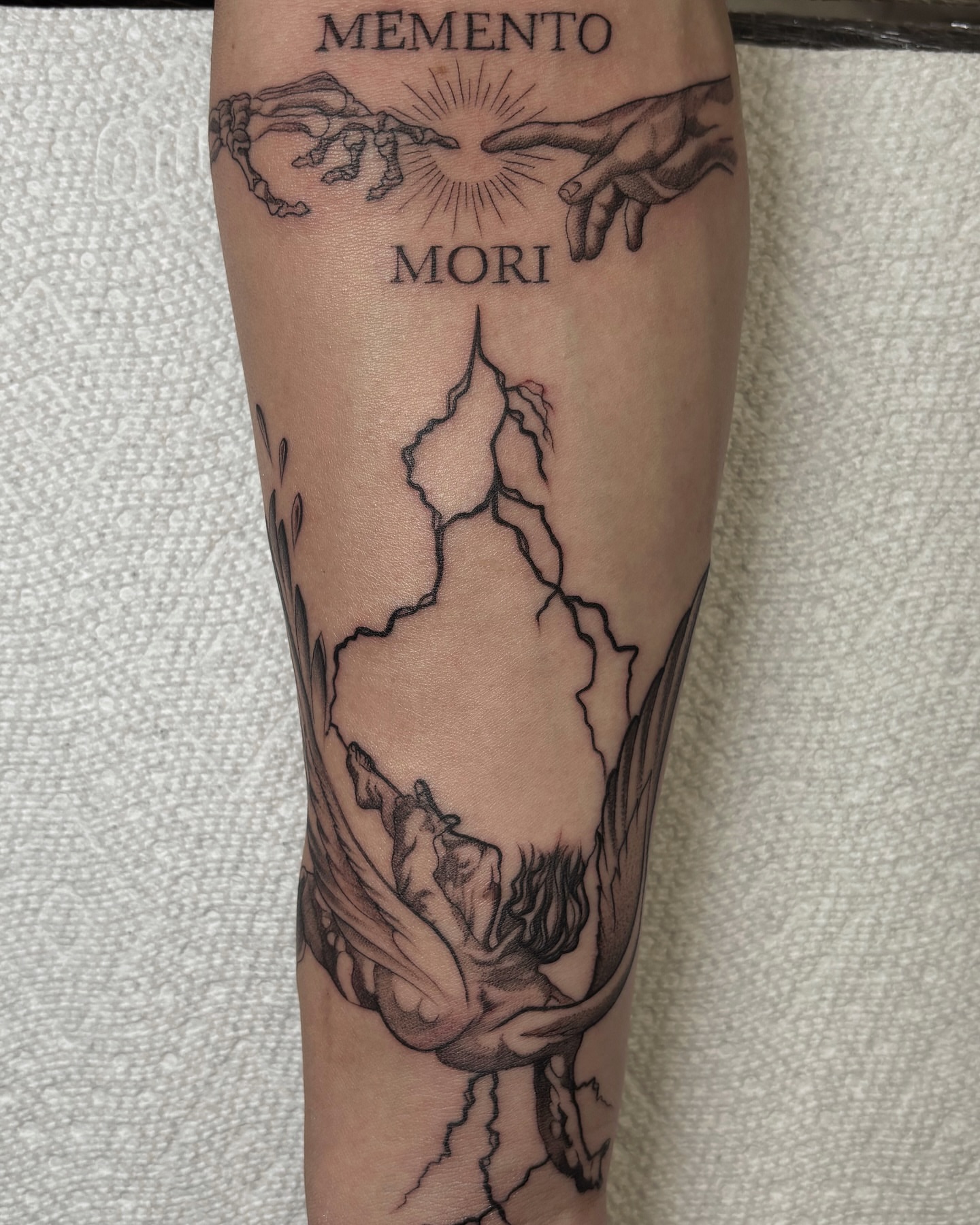 Memento mori black and grey tattoo on the forearm by Alejo Ibanez Tattoo