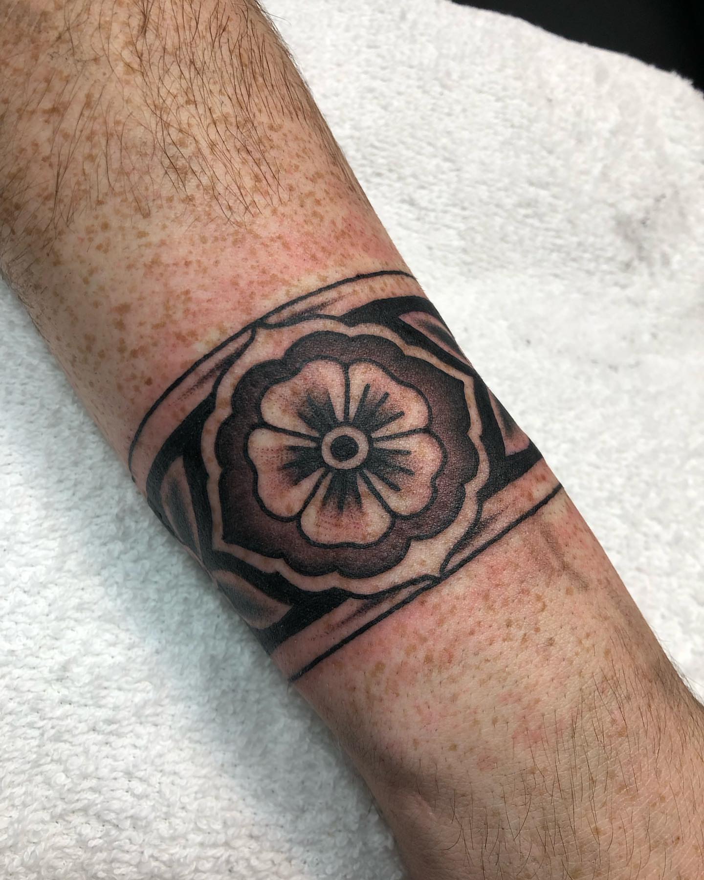 Flower black and grey tattoo on the forearm by Matt Klass