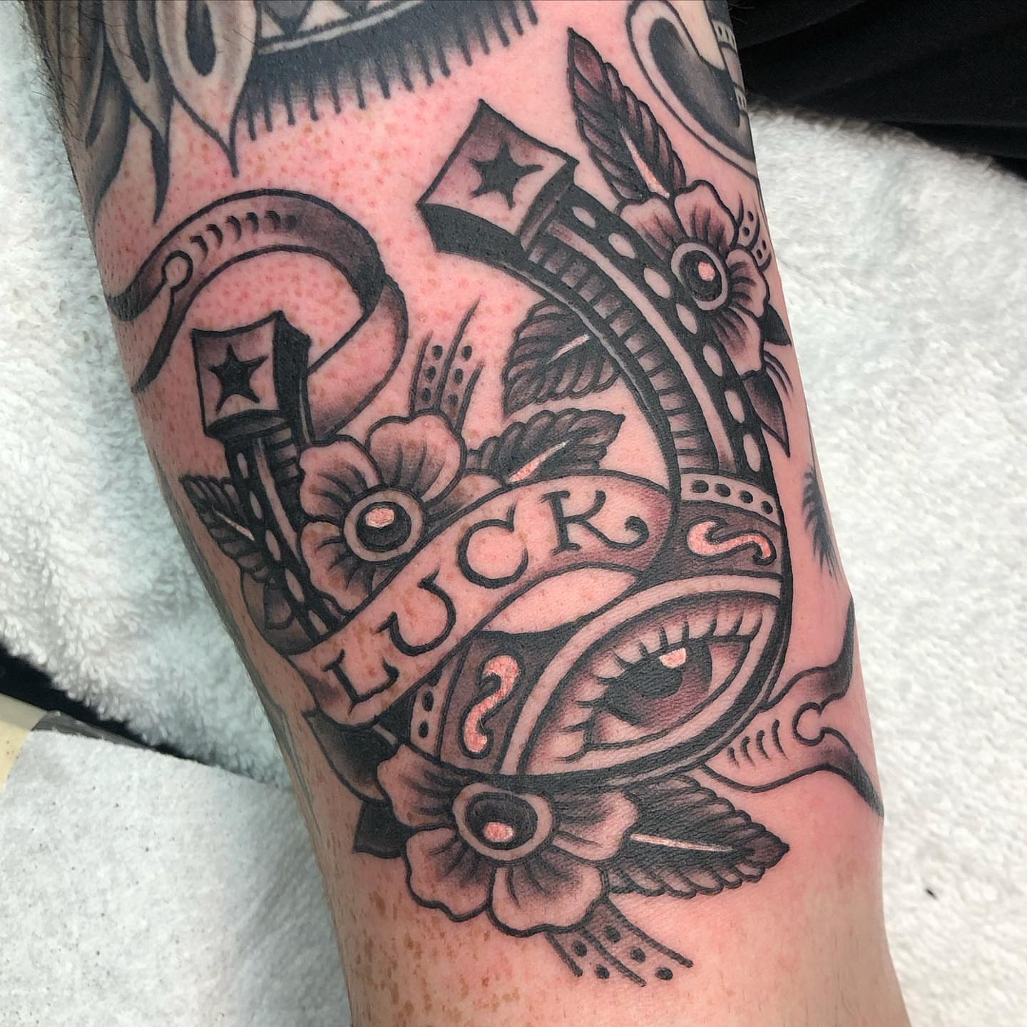 Eye and floral motifs American traditional tattoo on the forearm by Matt Klass