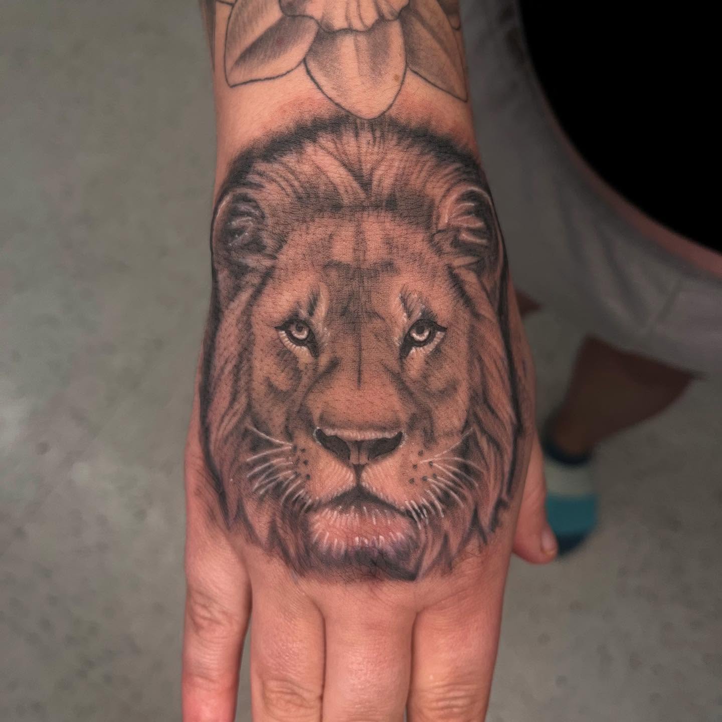 Lion realism tattoo on the hand by Kenzie Kirk