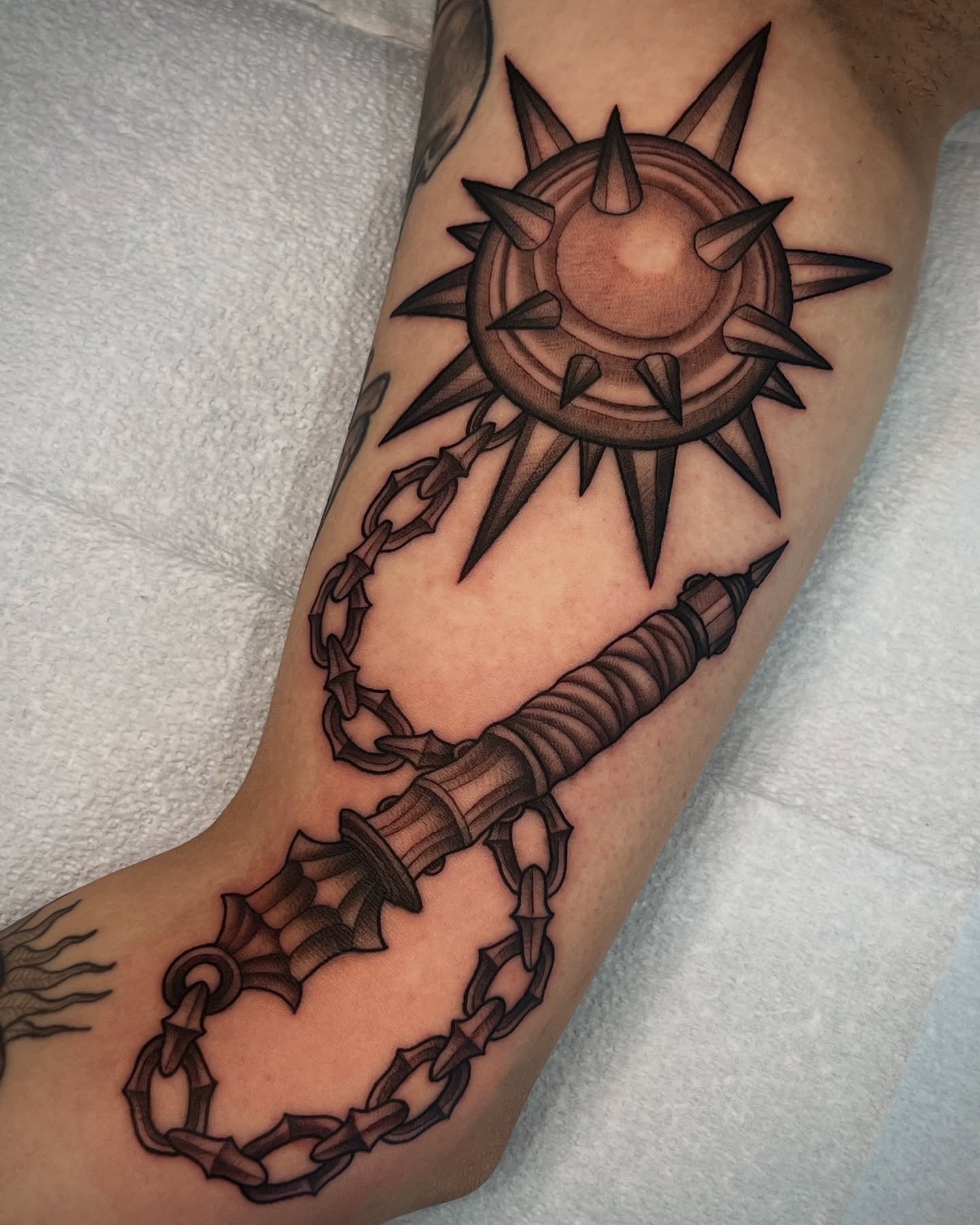 Compass and anchor chain black and grey tattoo on the forearm by Mia Manzanedo