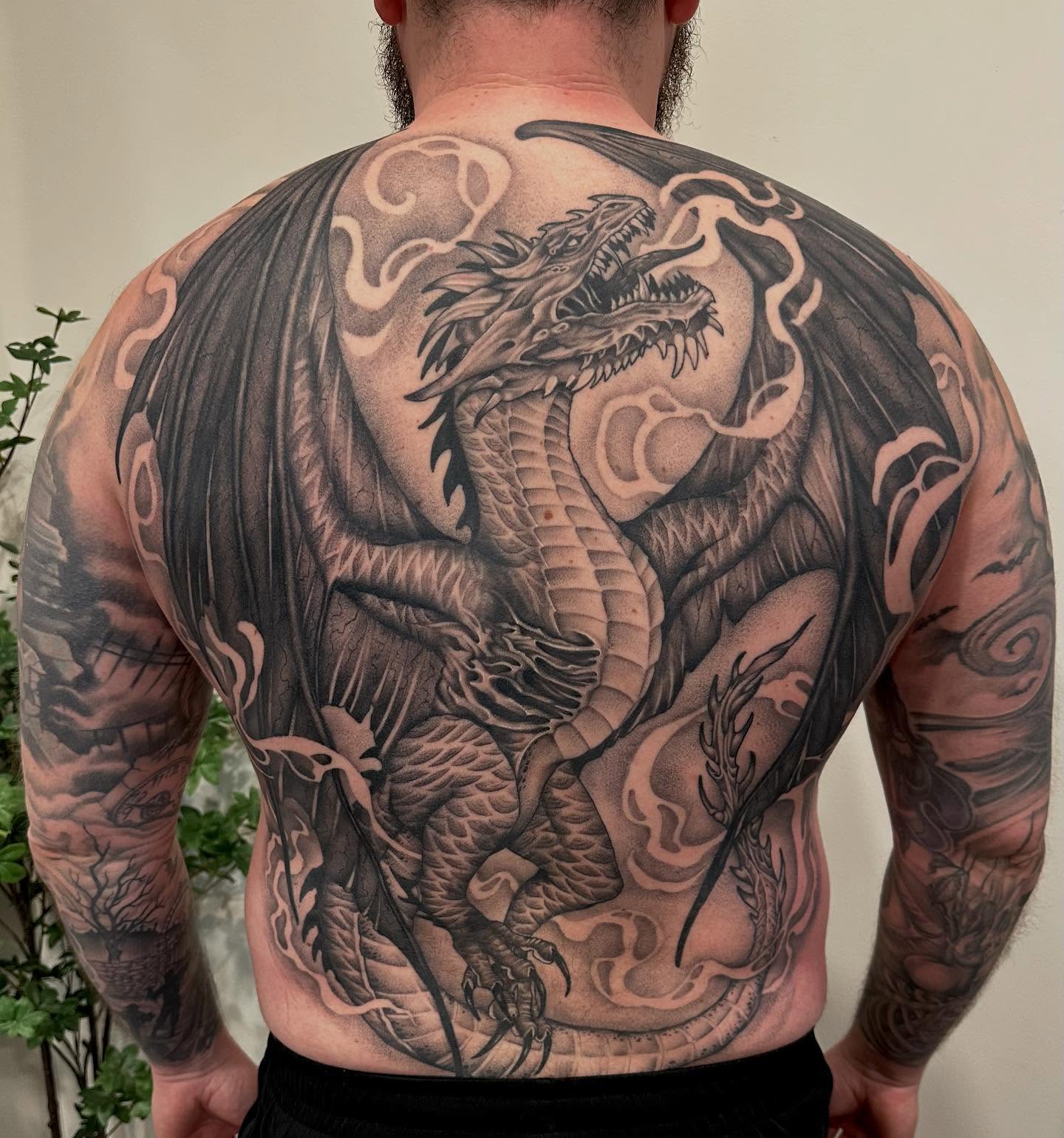 Dragon realism tattoo on the back by Kate Darling