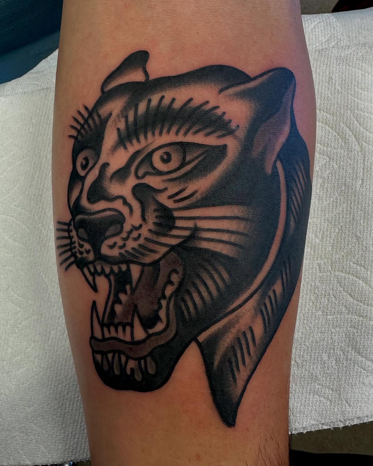 Panther head American traditional tattoo on the forearm by Dave G