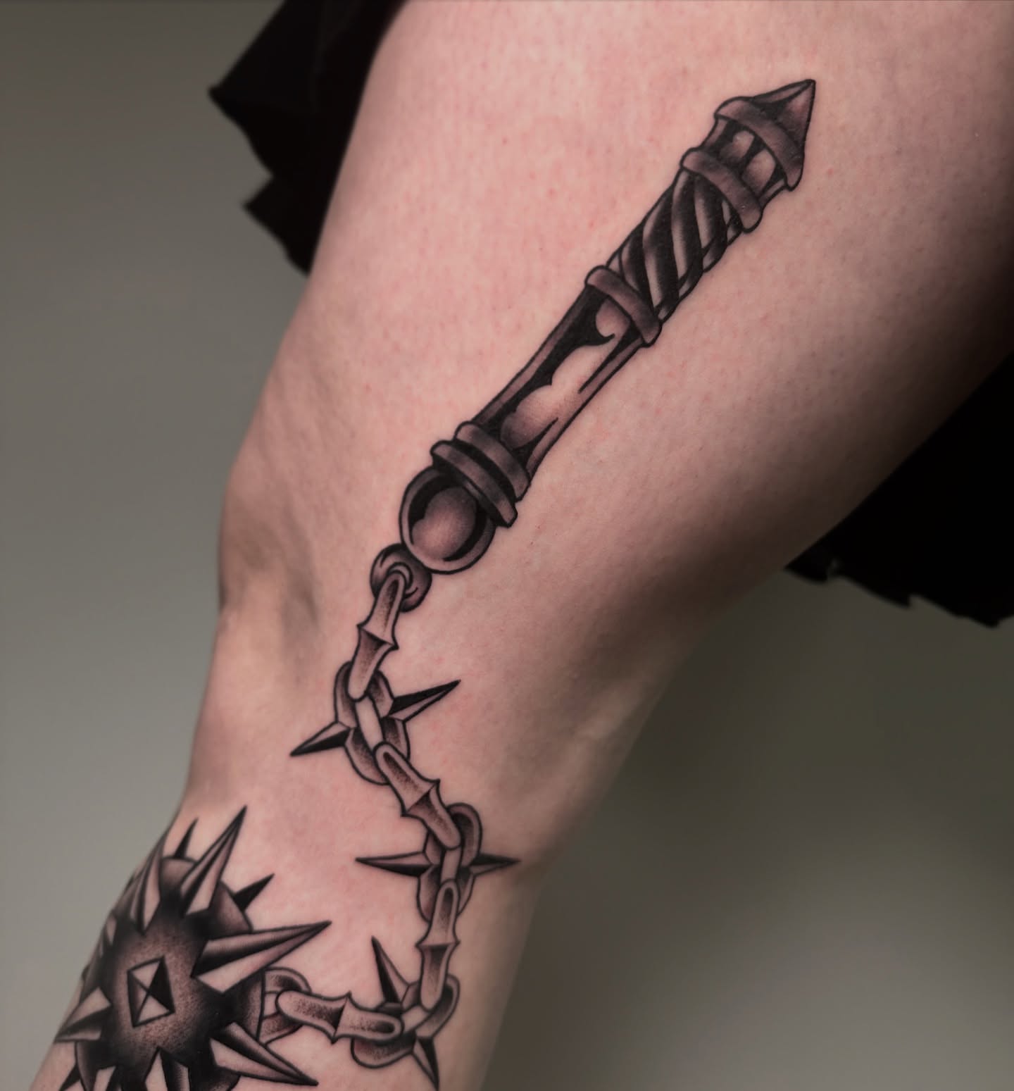 Chainmaille dagger black and grey tattoo on the forearm by Patrick Whiting