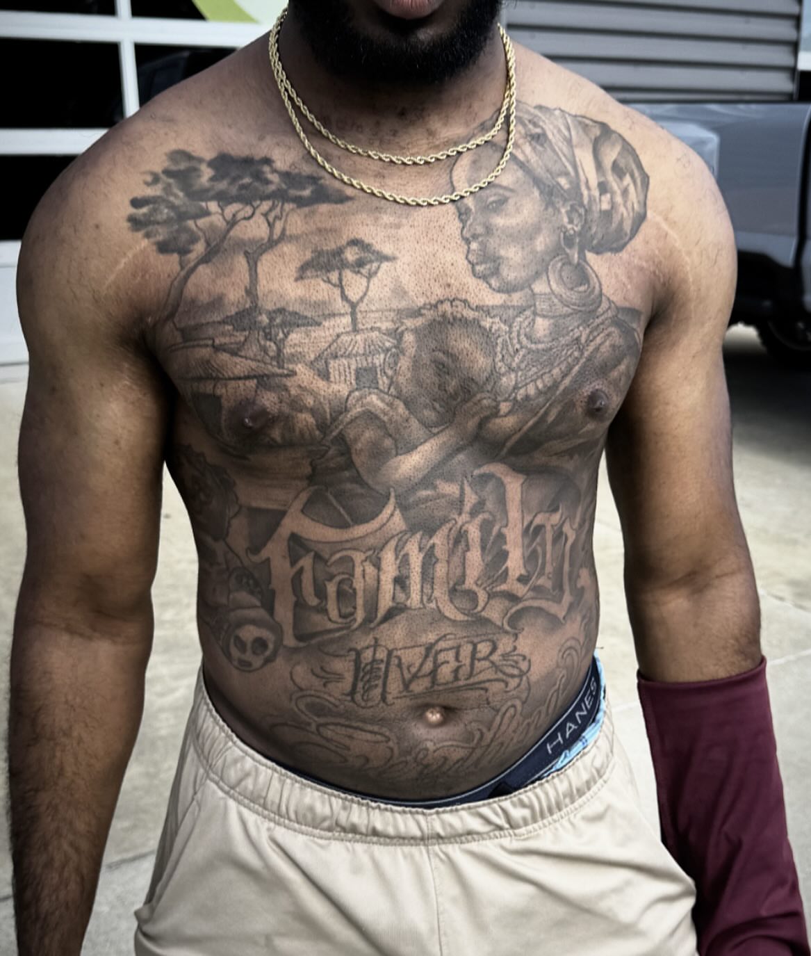 Family black and grey tattoo on the chest by Jared McGee
