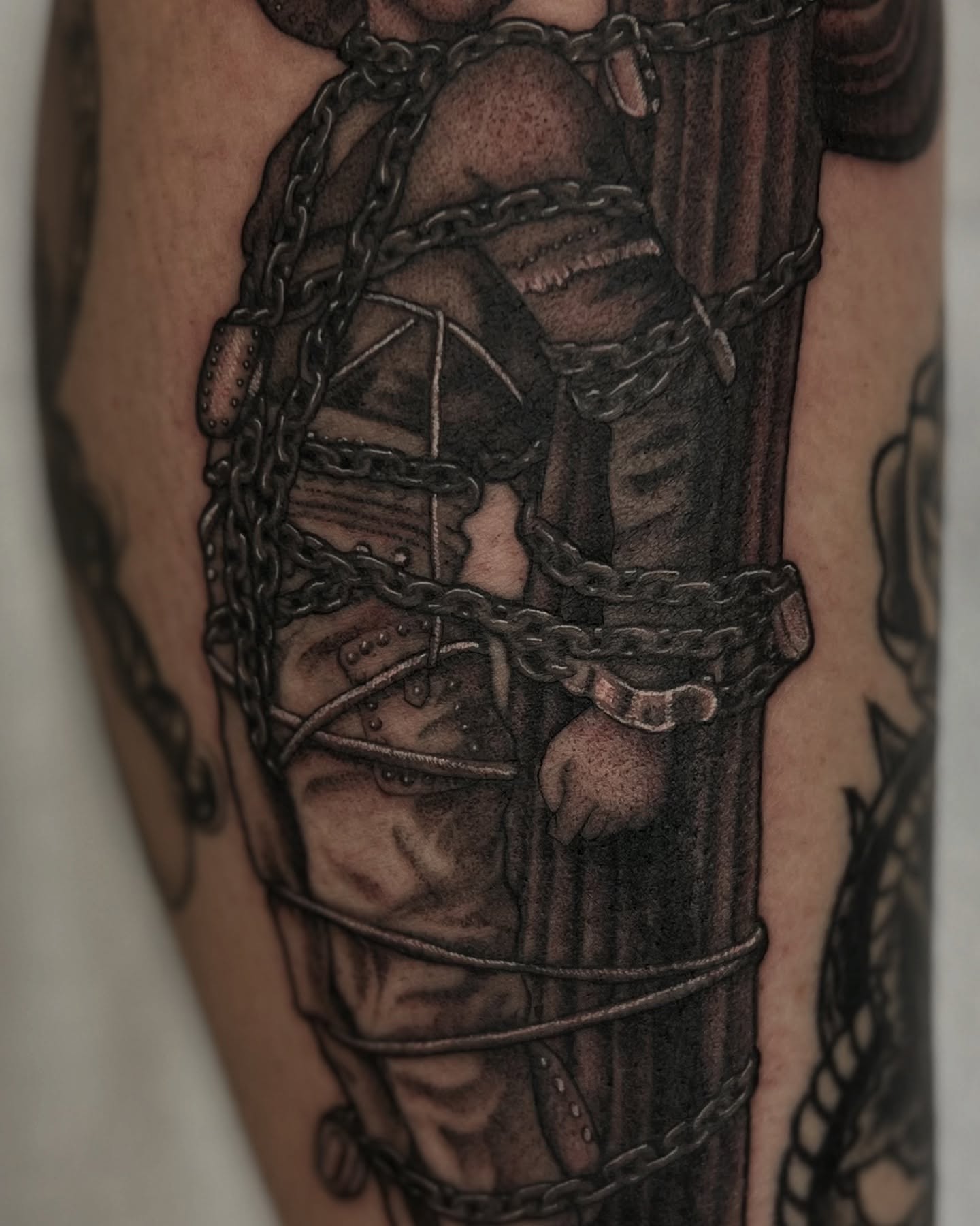 Man in chains realism tattoo on the forearm by Valerie Dominguez