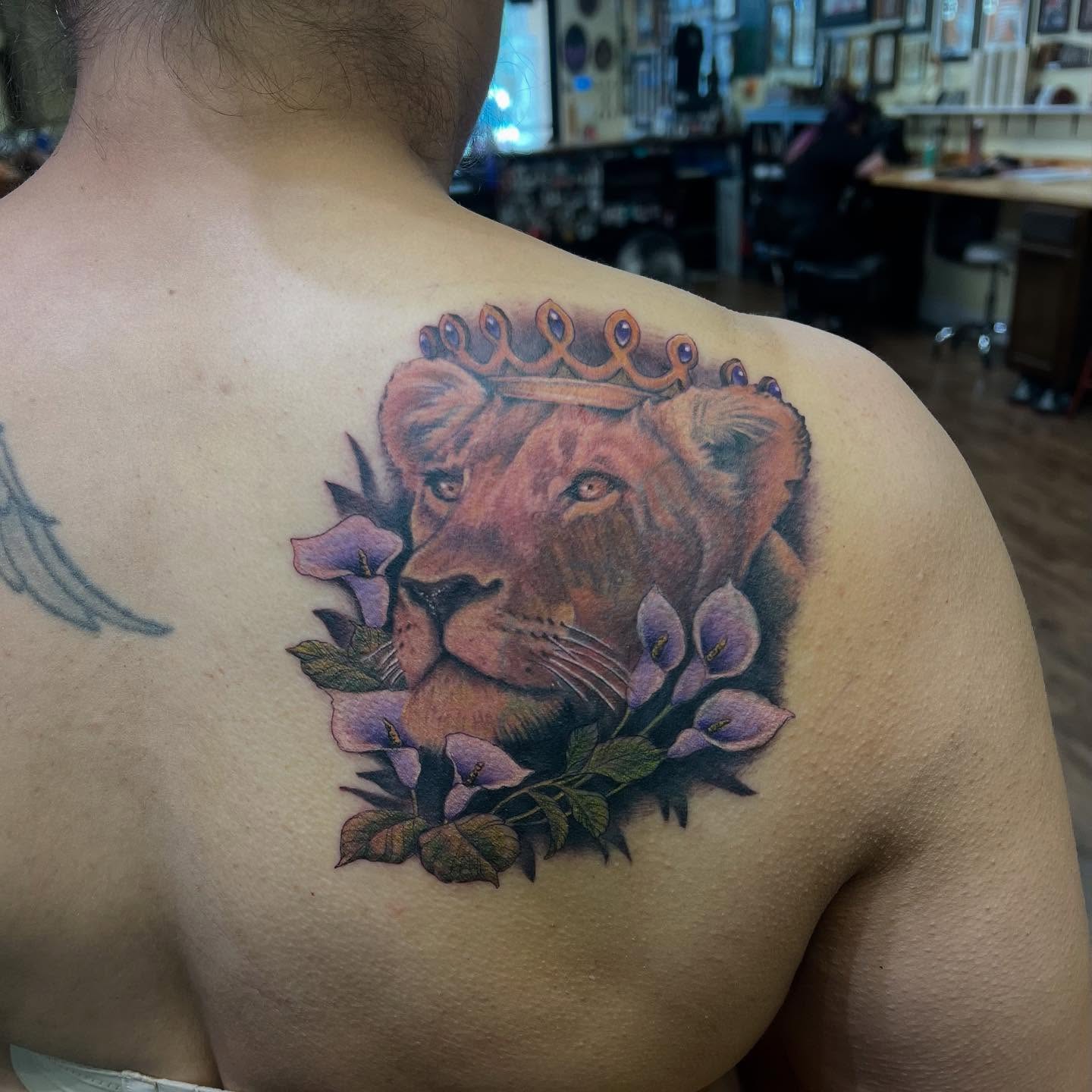 Lion with crown realism tattoo on the shoulder by Bob Simmons