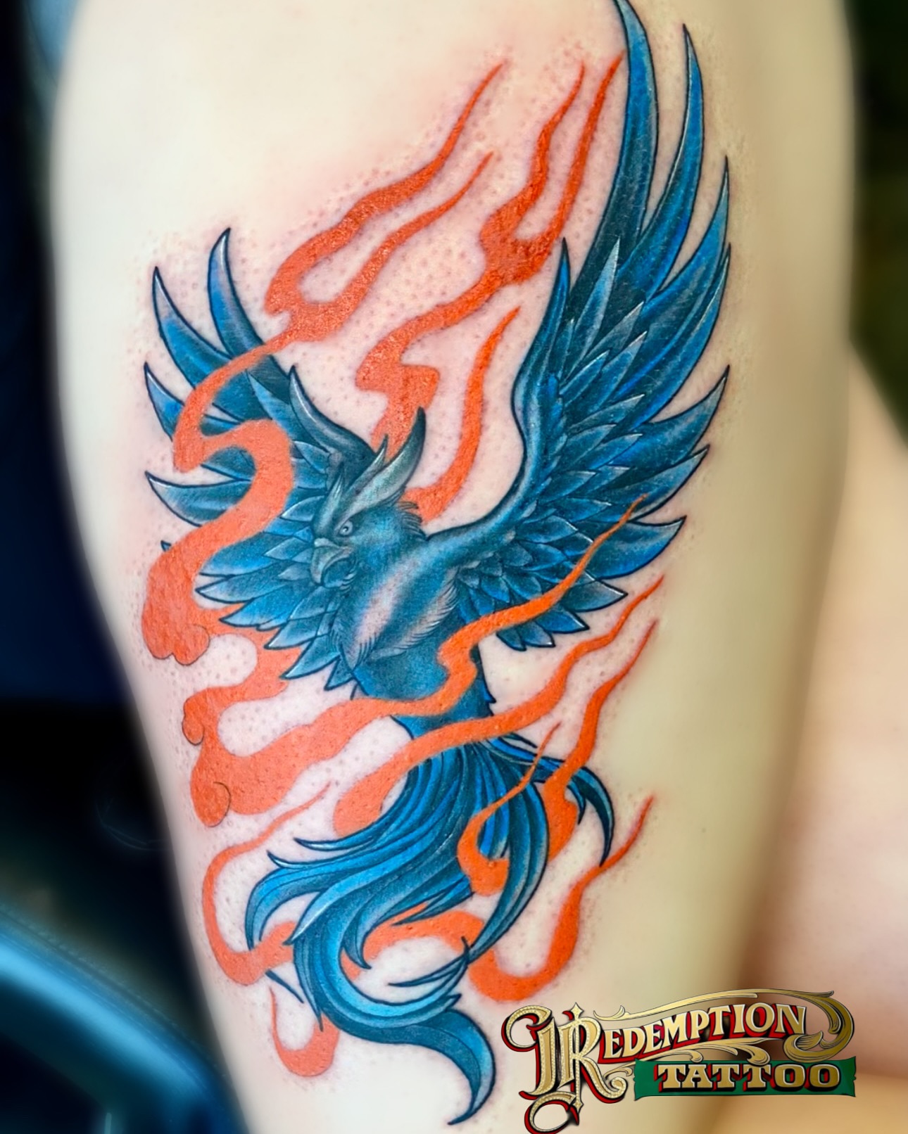 Phoenix with flames realism tattoo on the forearm by Dorrough Tattooer
