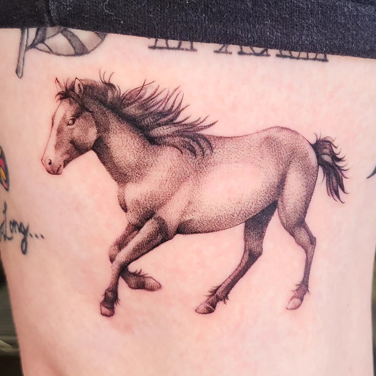 Galloping horse realism tattoo on the thigh by Brenda Juarez - Tattoo Artist