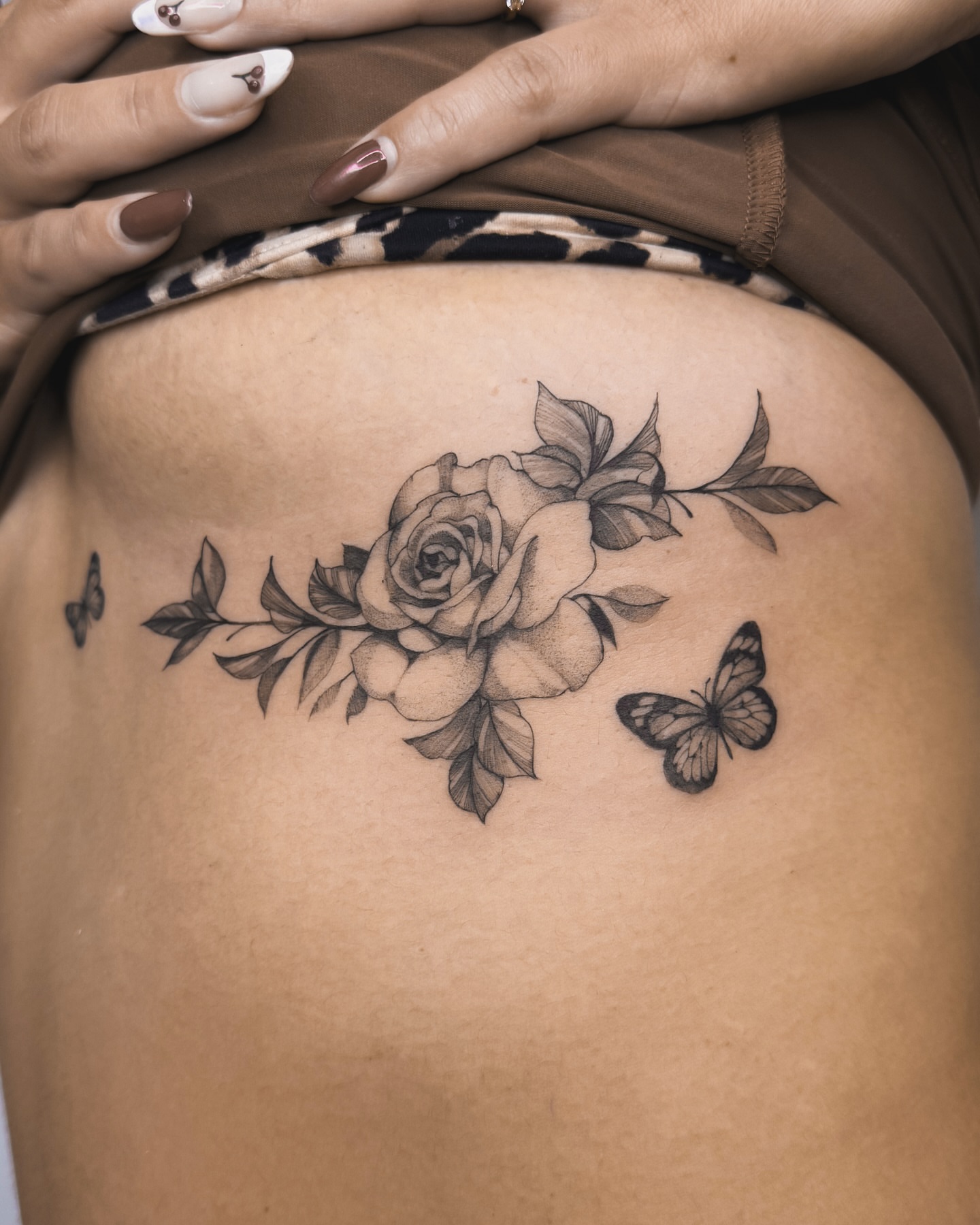 Rose and butterfly realism tattoo on the thigh by Blackwork & microrealism tattoos