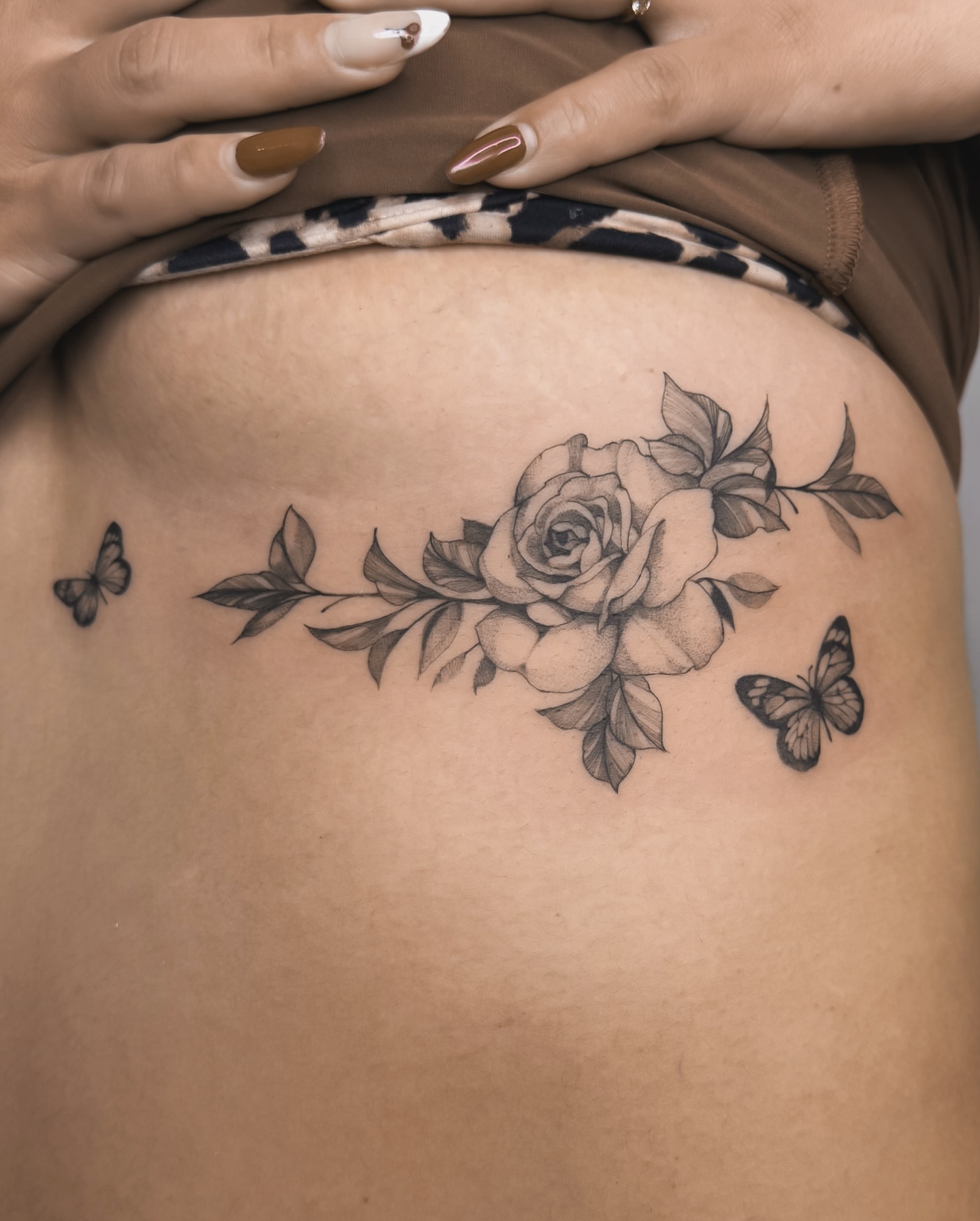 Rose and butterflies realism tattoo on the thigh by Blackwork & microrealism tattoos