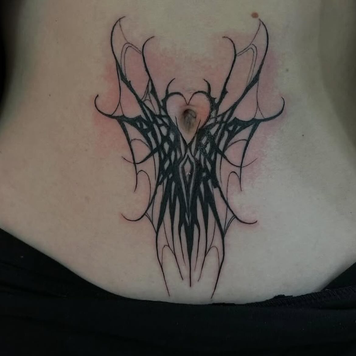 Abstract design black and grey tattoo on the torso by Haley Winfree