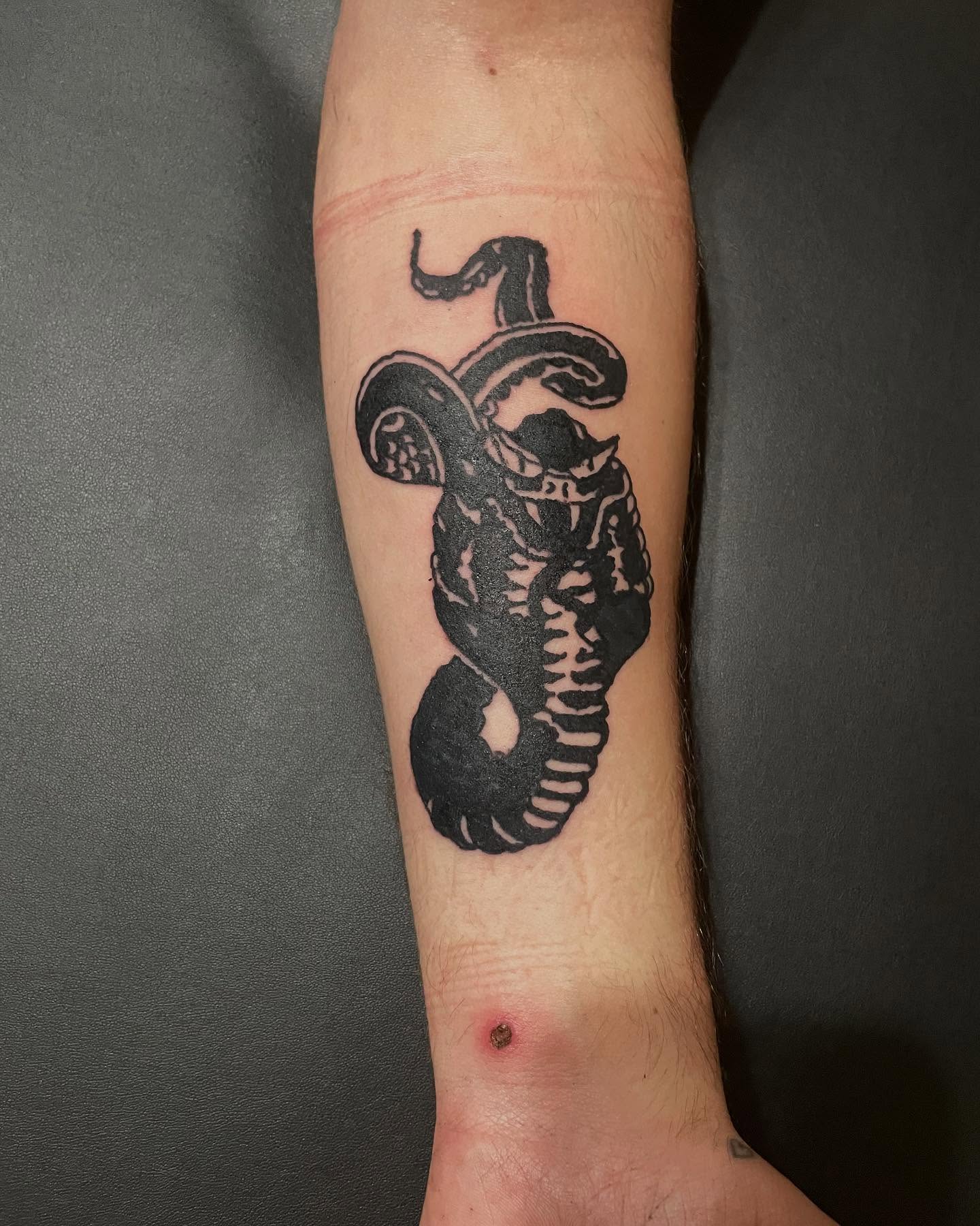 Snake black and grey tattoo on the forearm by @emotionalthugtattoo