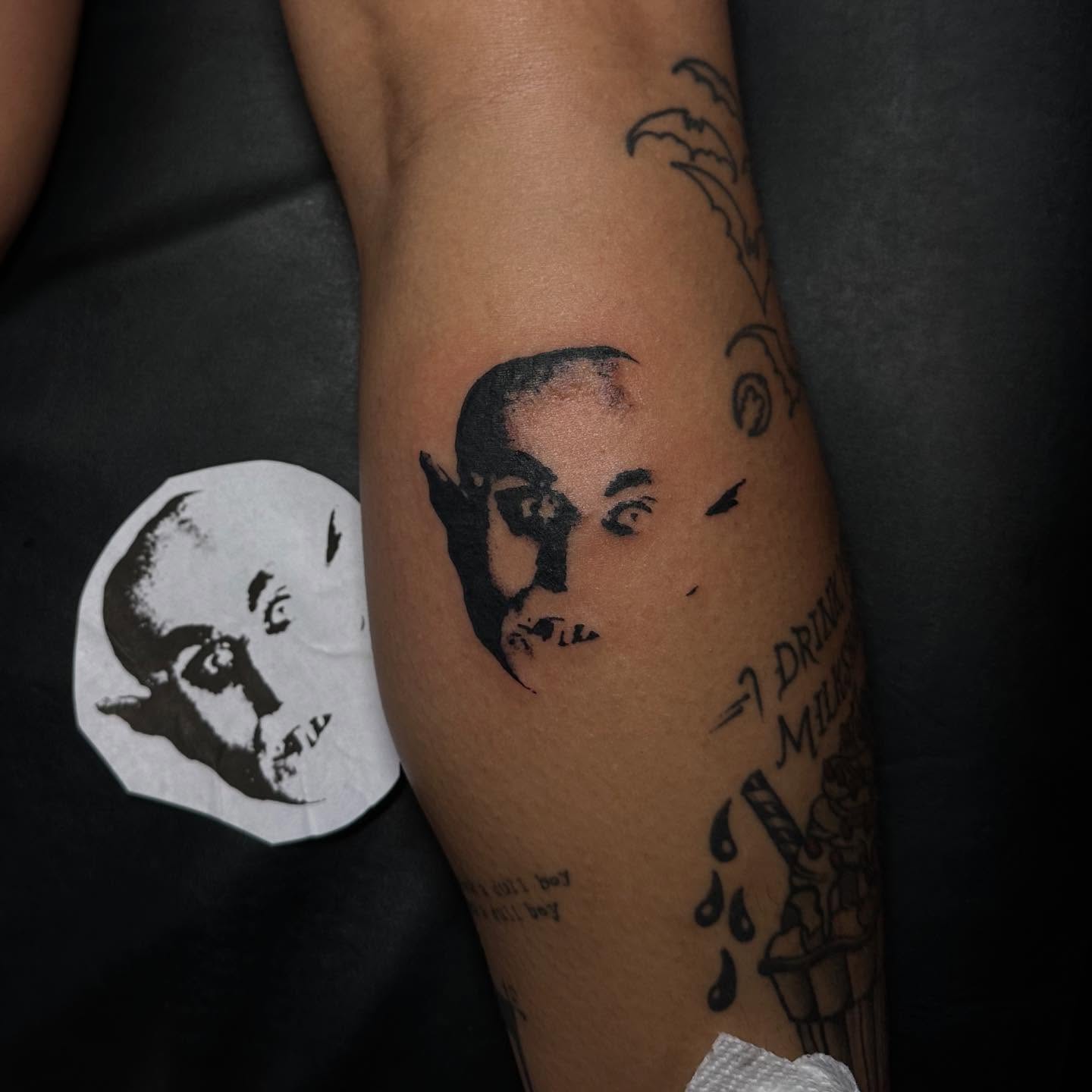 Man's face black and grey tattoo on the forearm by Abigail Rae