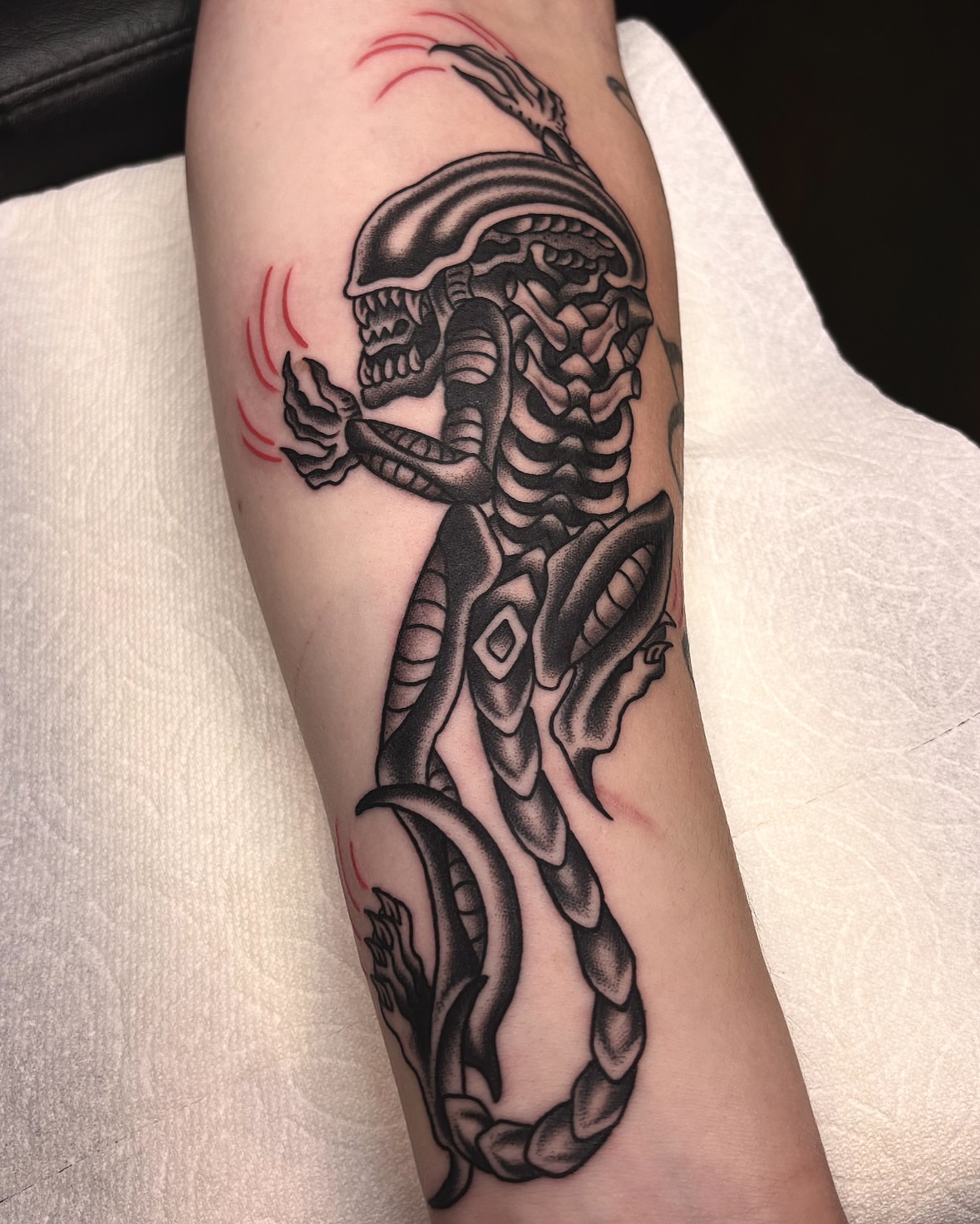 Alien creature realism tattoo on the forearm by ๐๐๐ฏ๐ข๐ซ